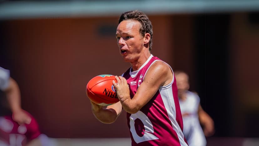 Man with disability playing inclusive AFL football as part of an APM sponsored event