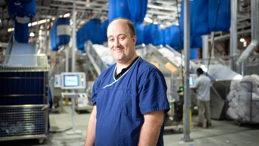 Participant Stephen smiles in his inclusive employment role