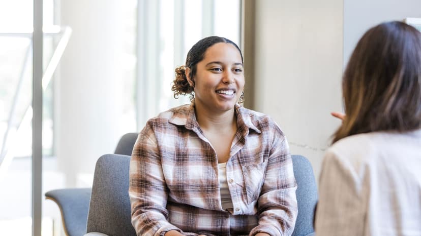 Young woman talking on couch