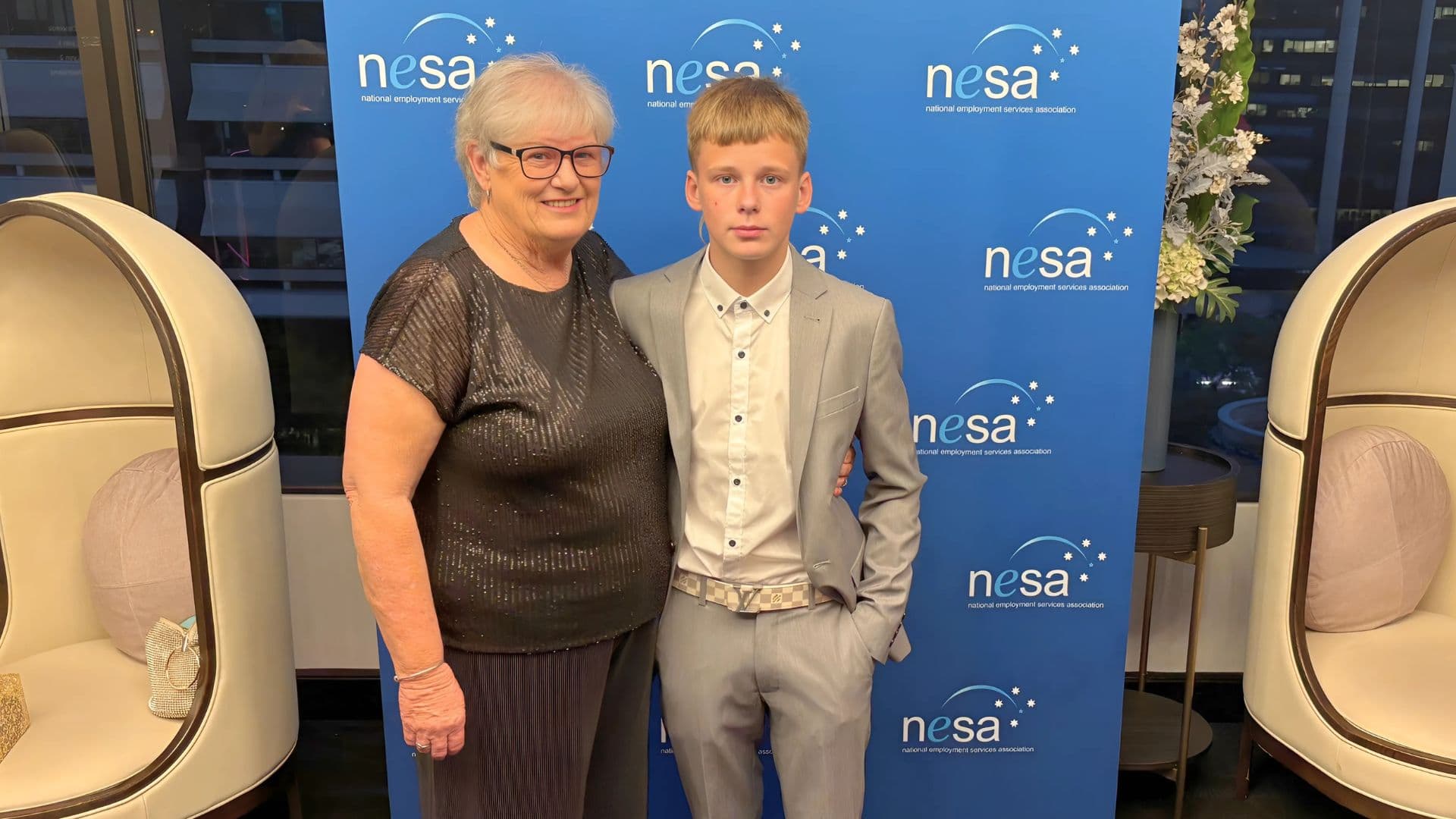 Quinn and his Gran stood by a NESA backdrop