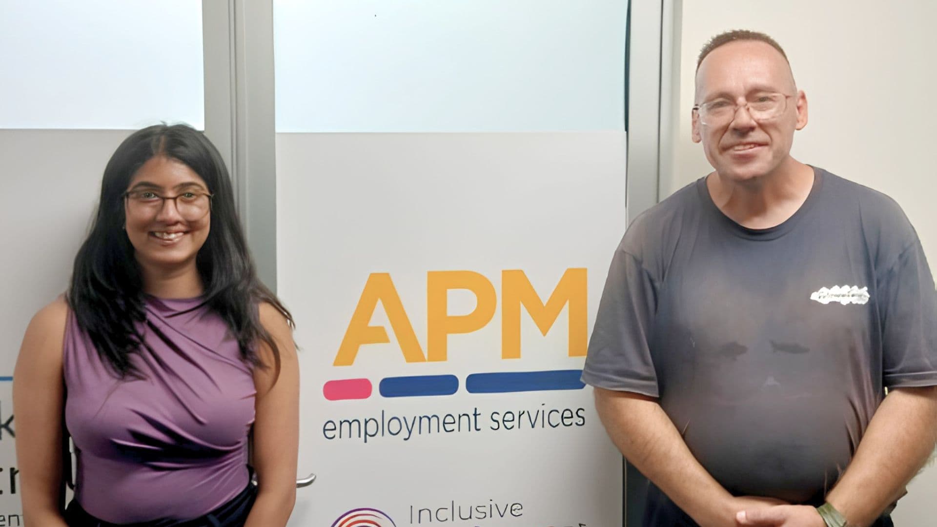 Workforce Australia participant Boby stands with an APM Employment Services consultant in the Surry Hills office.