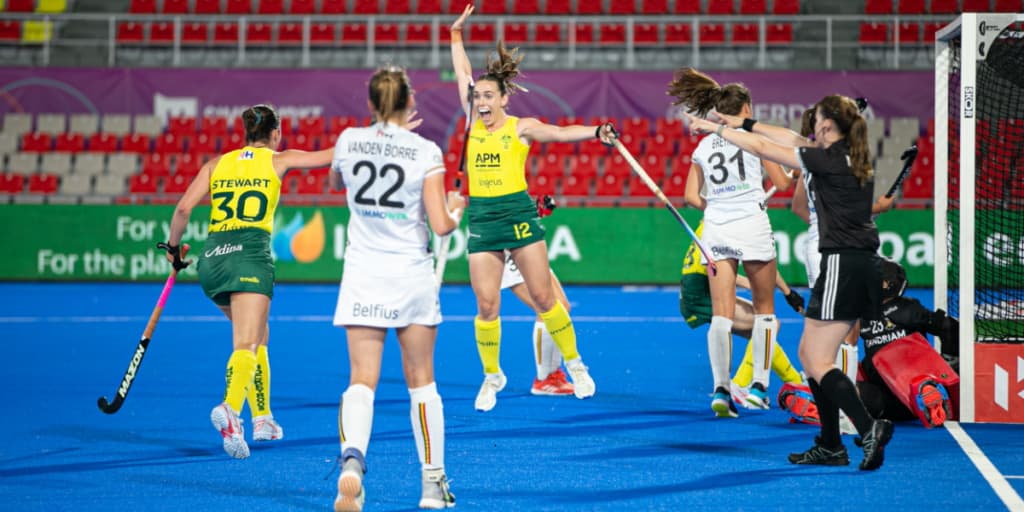 Hockeyroos celebrate a goal in their yellow APM-sponsored kits