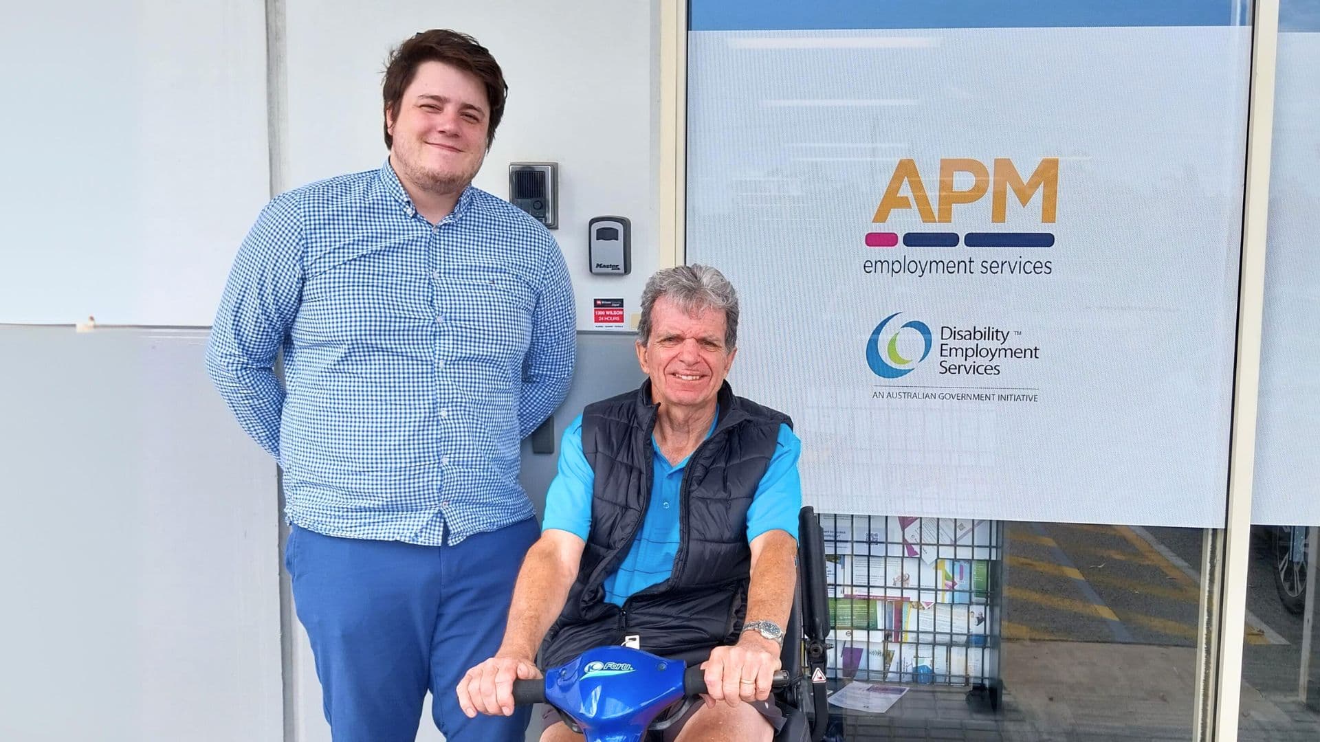 APM employment consultant Ricardo with DES participant Andrew in a mobility scooter