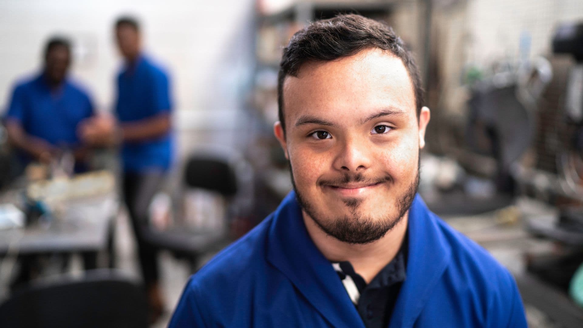 A man smiles as he works from a warehouse