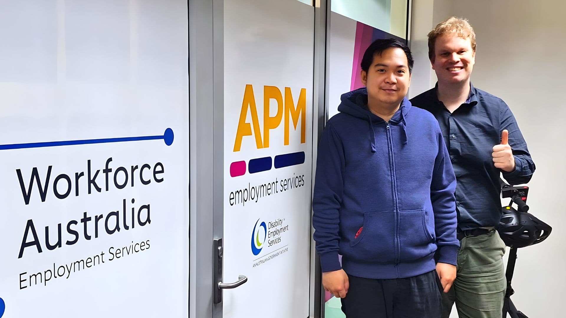 Marc standing with his APM employment consultant Matthew at a Workforce Australia Employment Services office.