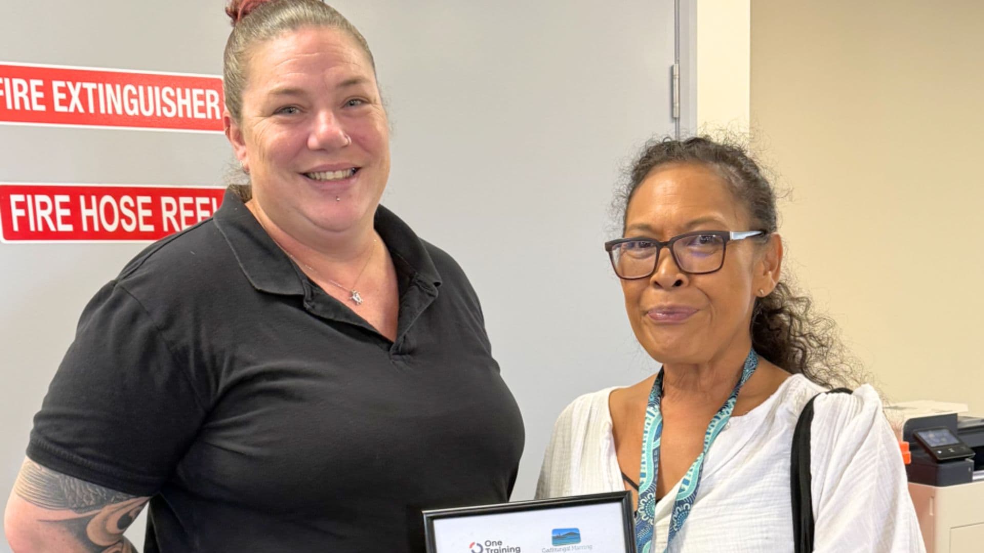 Phoebe stands with APM Employment Consultant Jade after finding work as an employment mentor