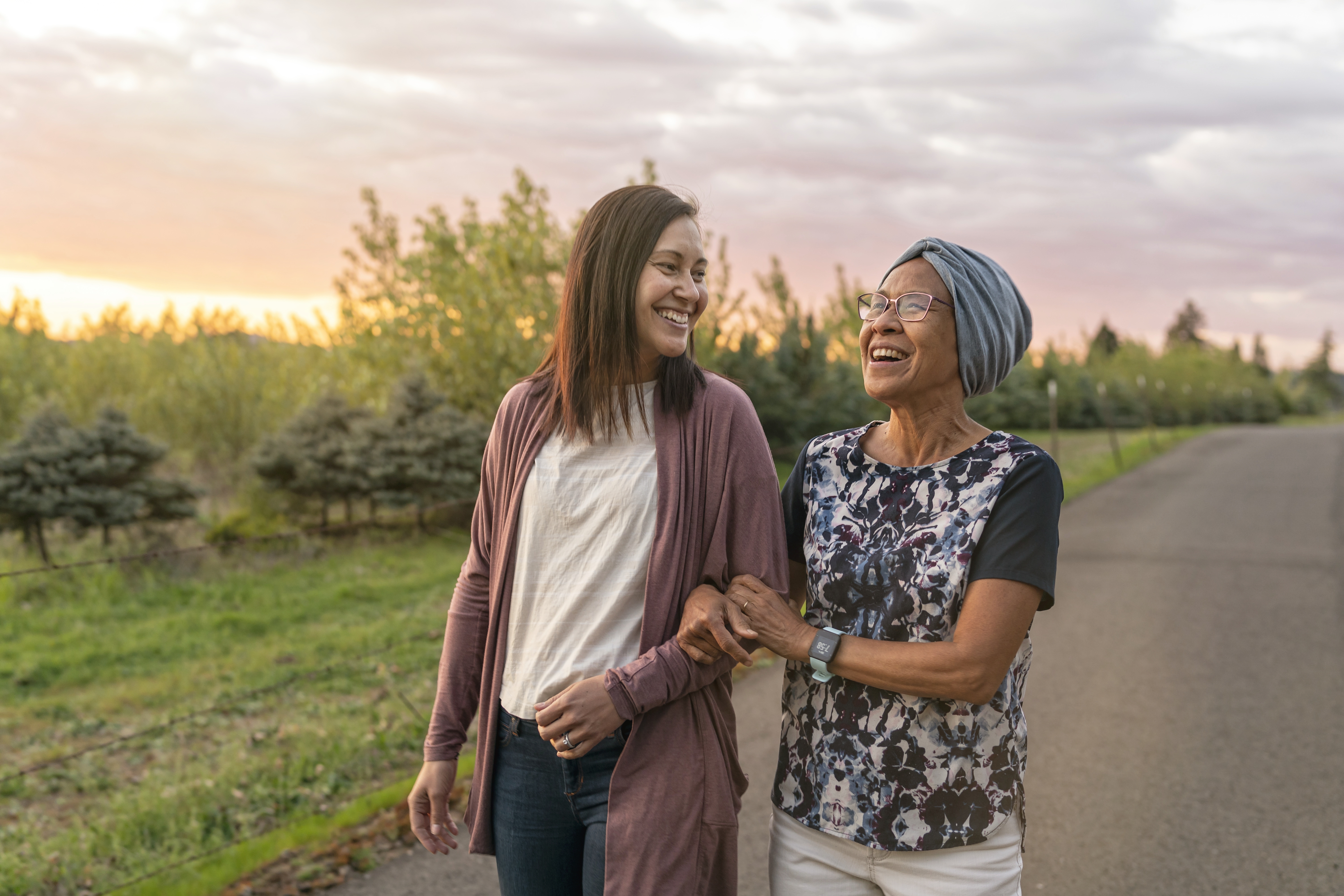 Two women walking outside and smiling