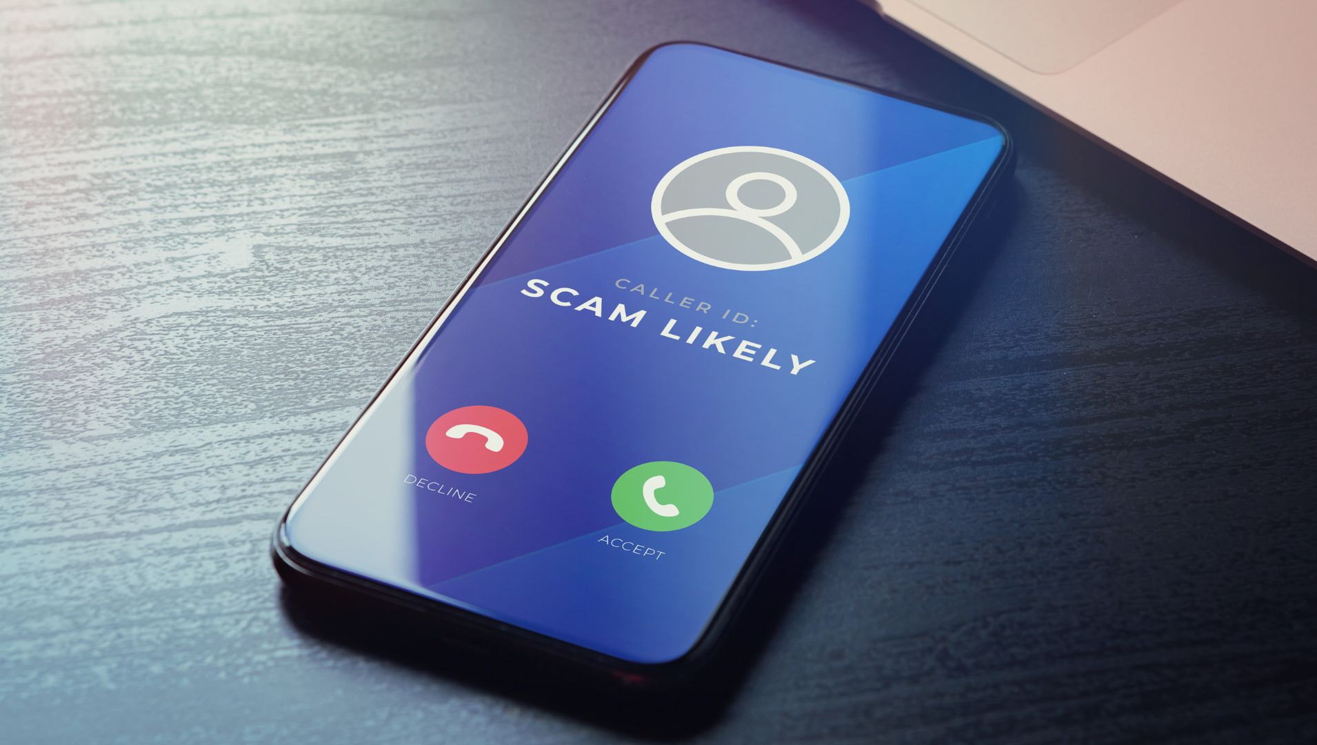 A phone with a scam caller identified and the option to accept or decline the call.