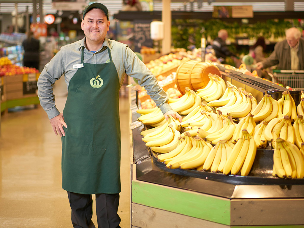woolworths employee holding bananas