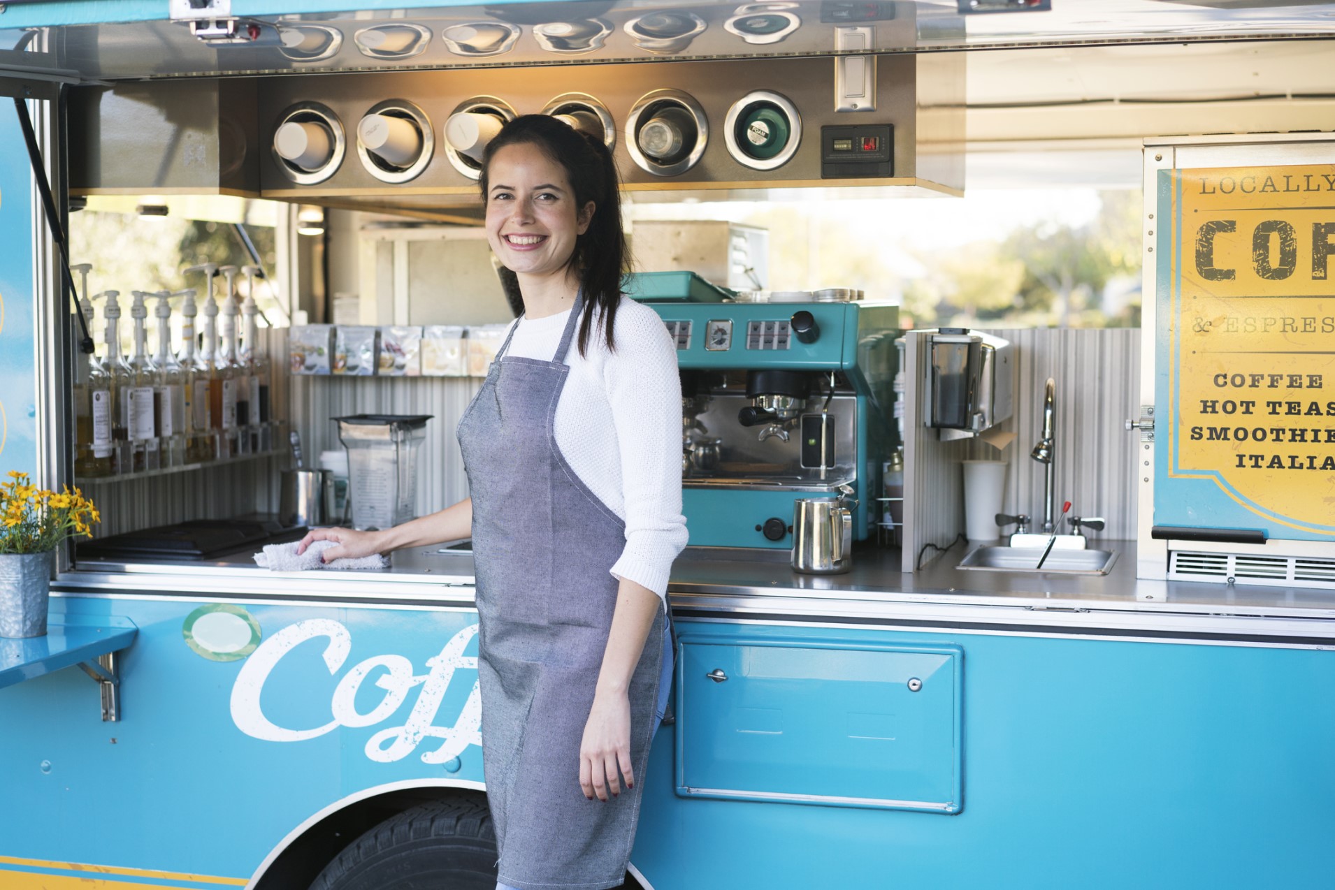 young woman with a smile on her face for overcoming her depression and starting a new job at a takeaway coffee van