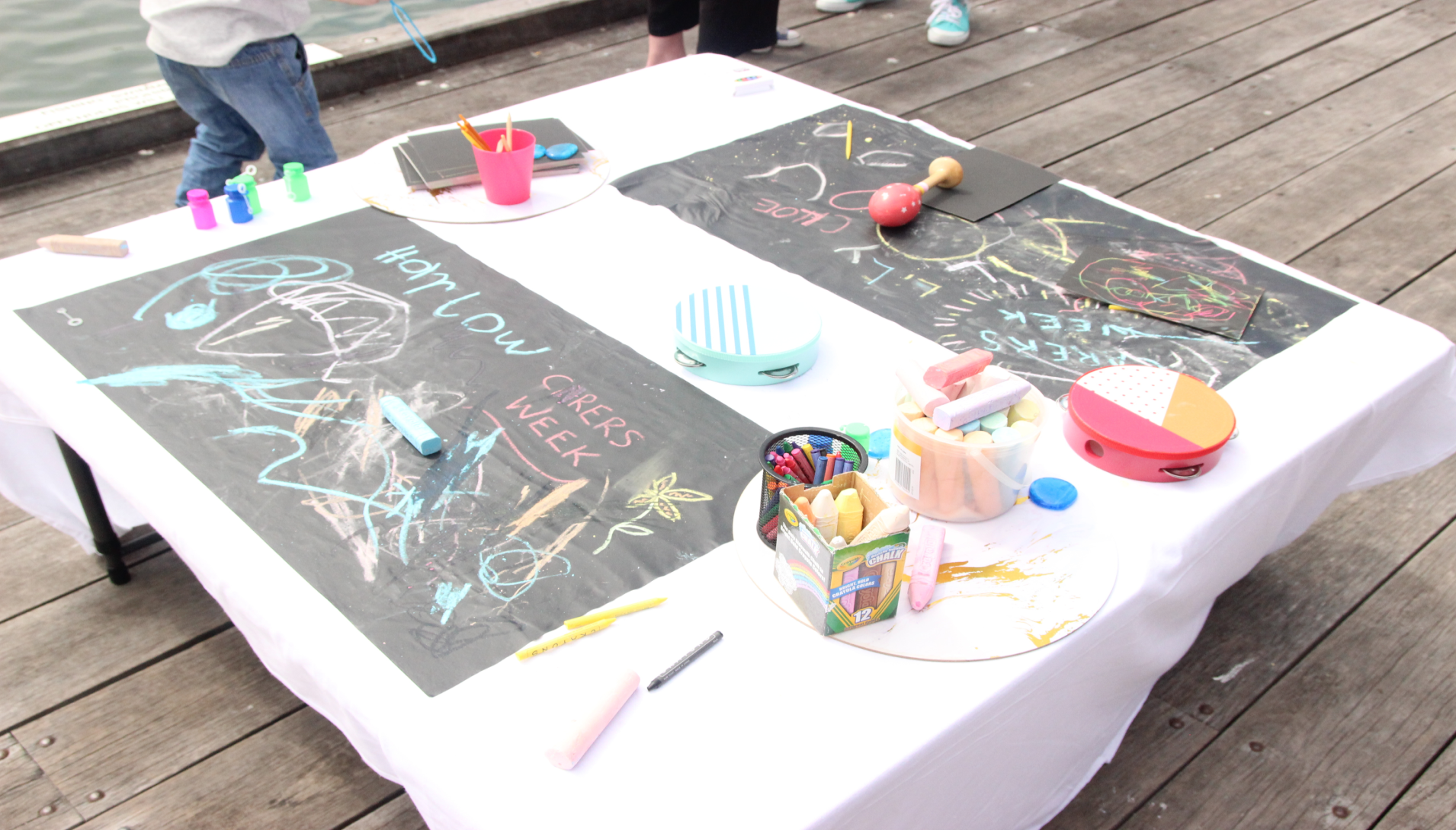 a children's art table with many colourful pieces of art on it