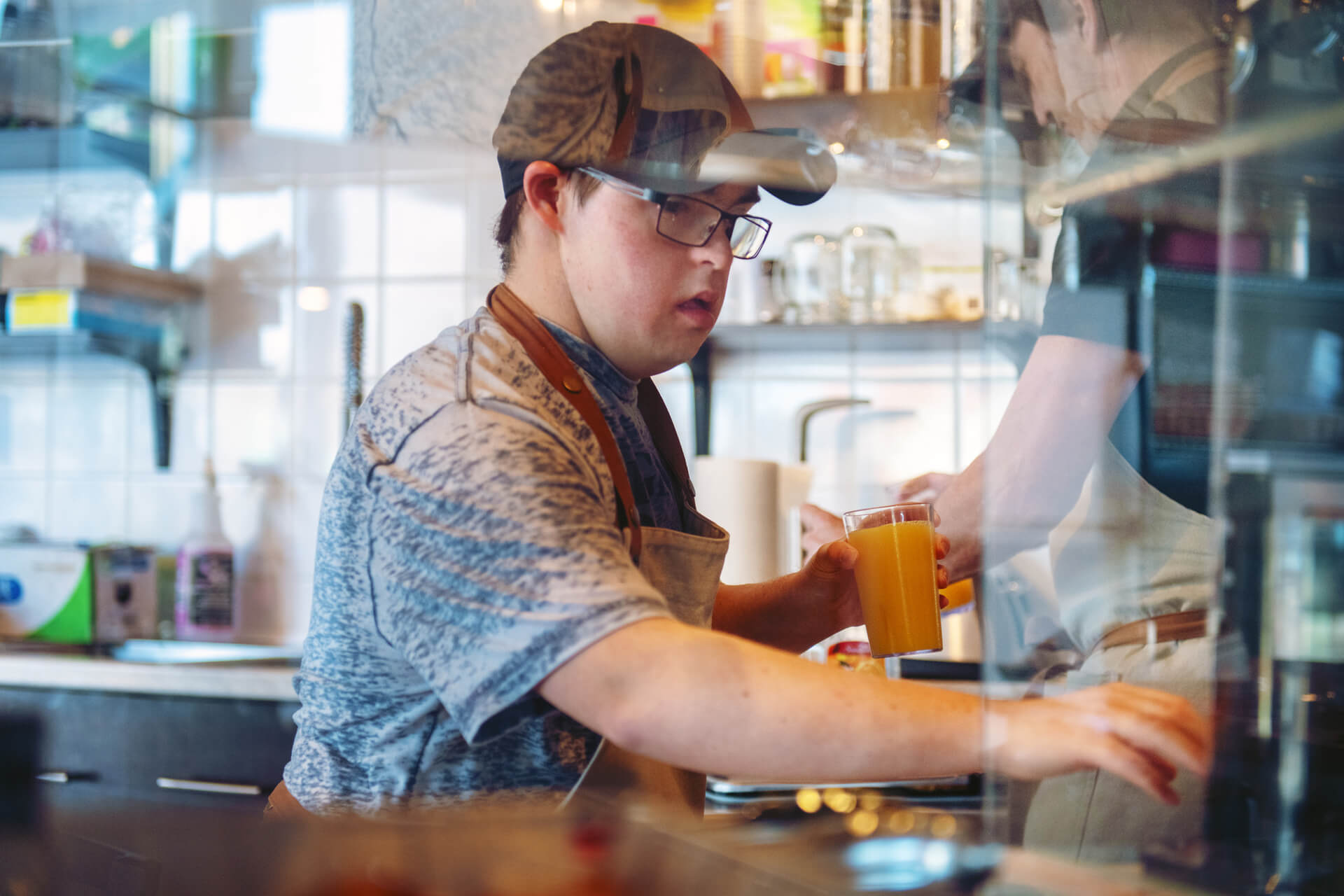 Young male with intellectual disability working in a cafe