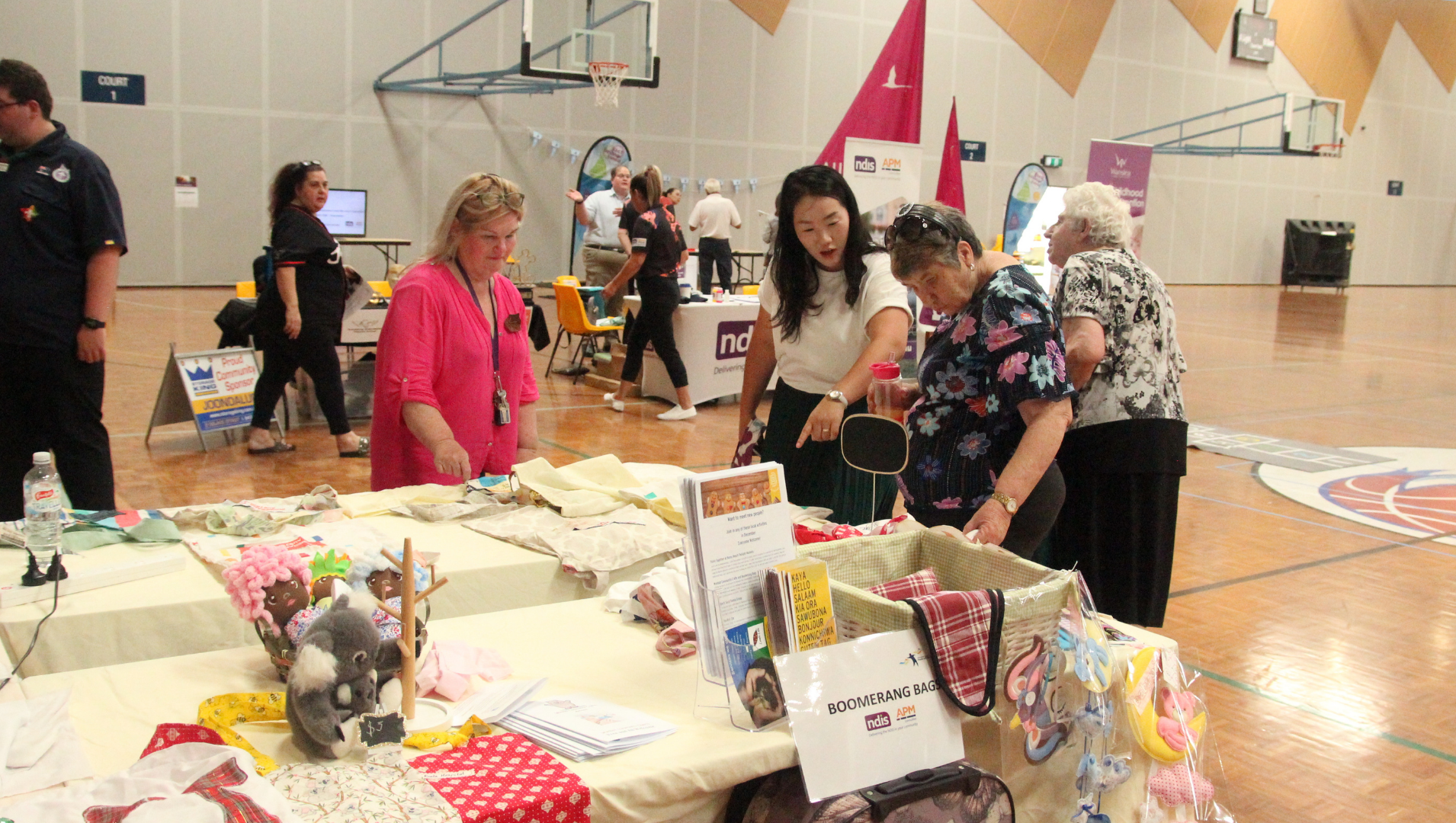 Attendees at the APM communities event admiring some of the items on display
