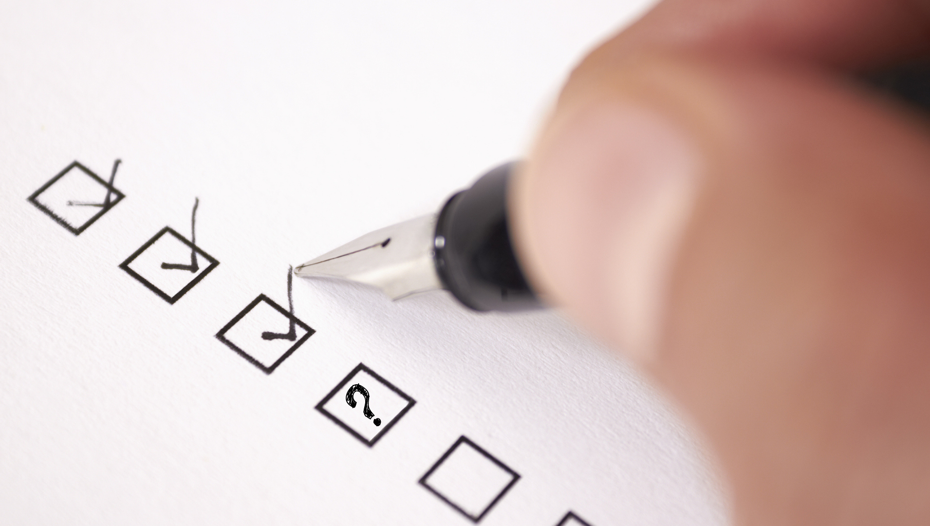A hand hovering over a checklist with 3 boxes ticked and one with a question mark in it