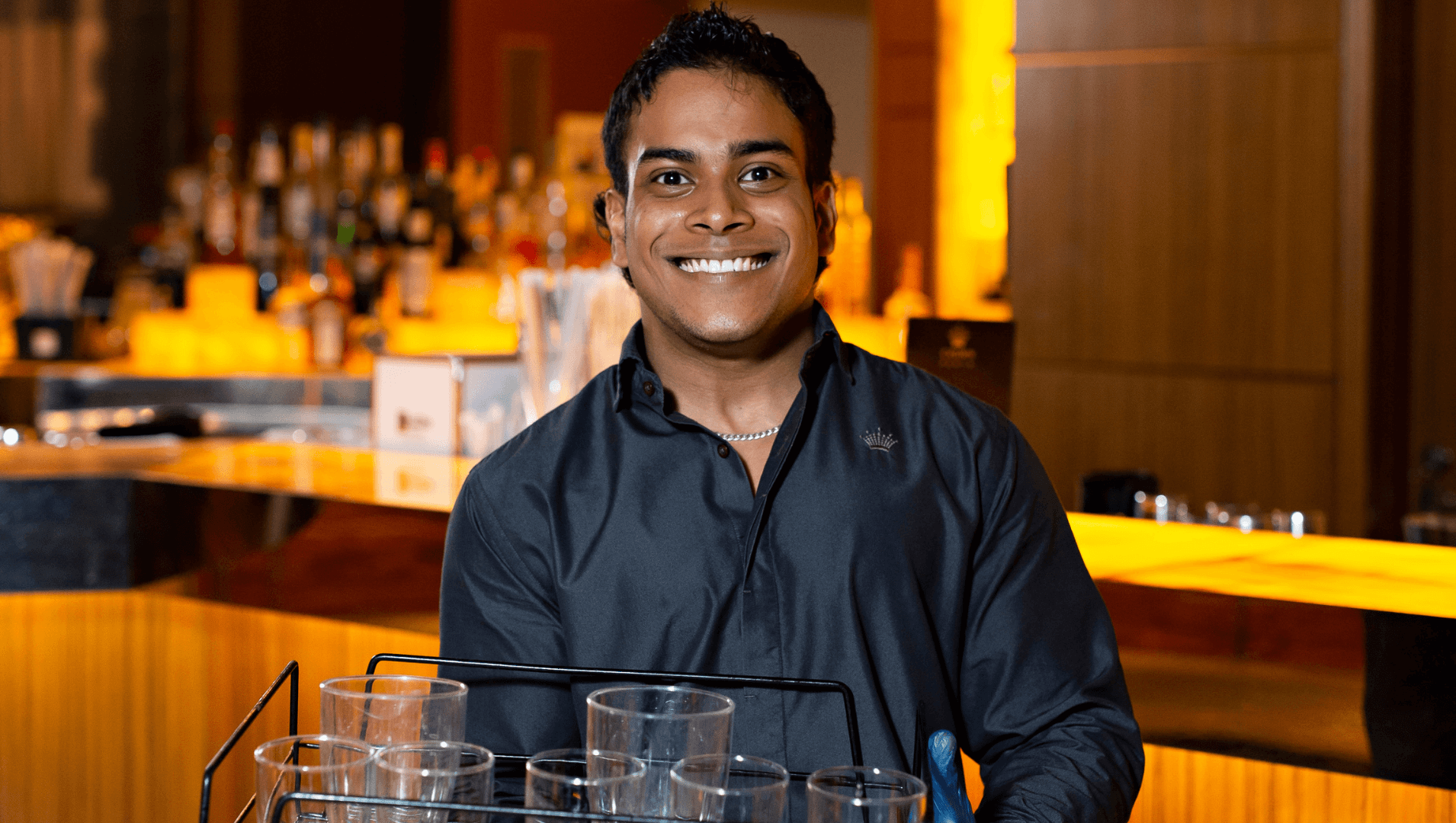 man smiling in a bar setting