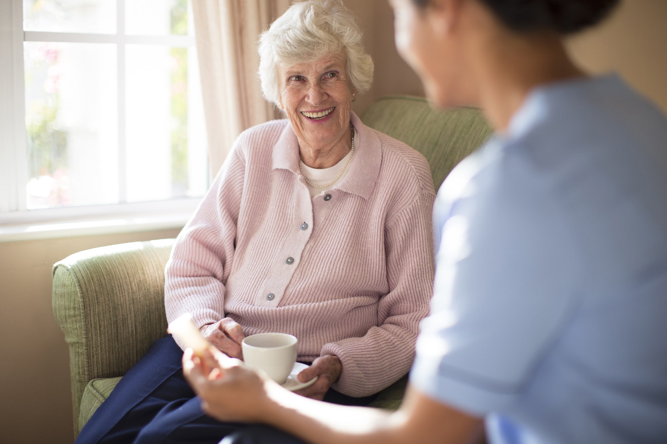 Older lady in a residential home talking to an assessor