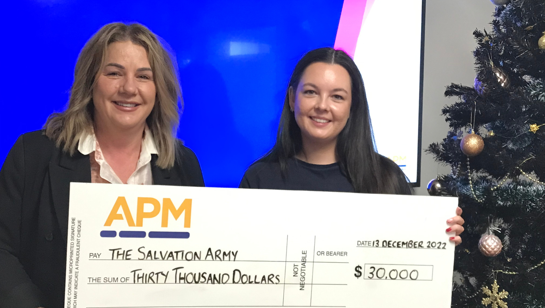 APM CEO of Employment Services Karen Rainbow and Grace Lacy from the Salvation Arm y are pictures together holding a cheque for $30,000