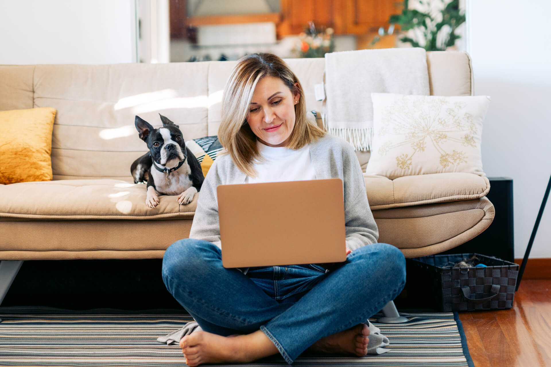 Woman who has lived with depression with her dog and laptop