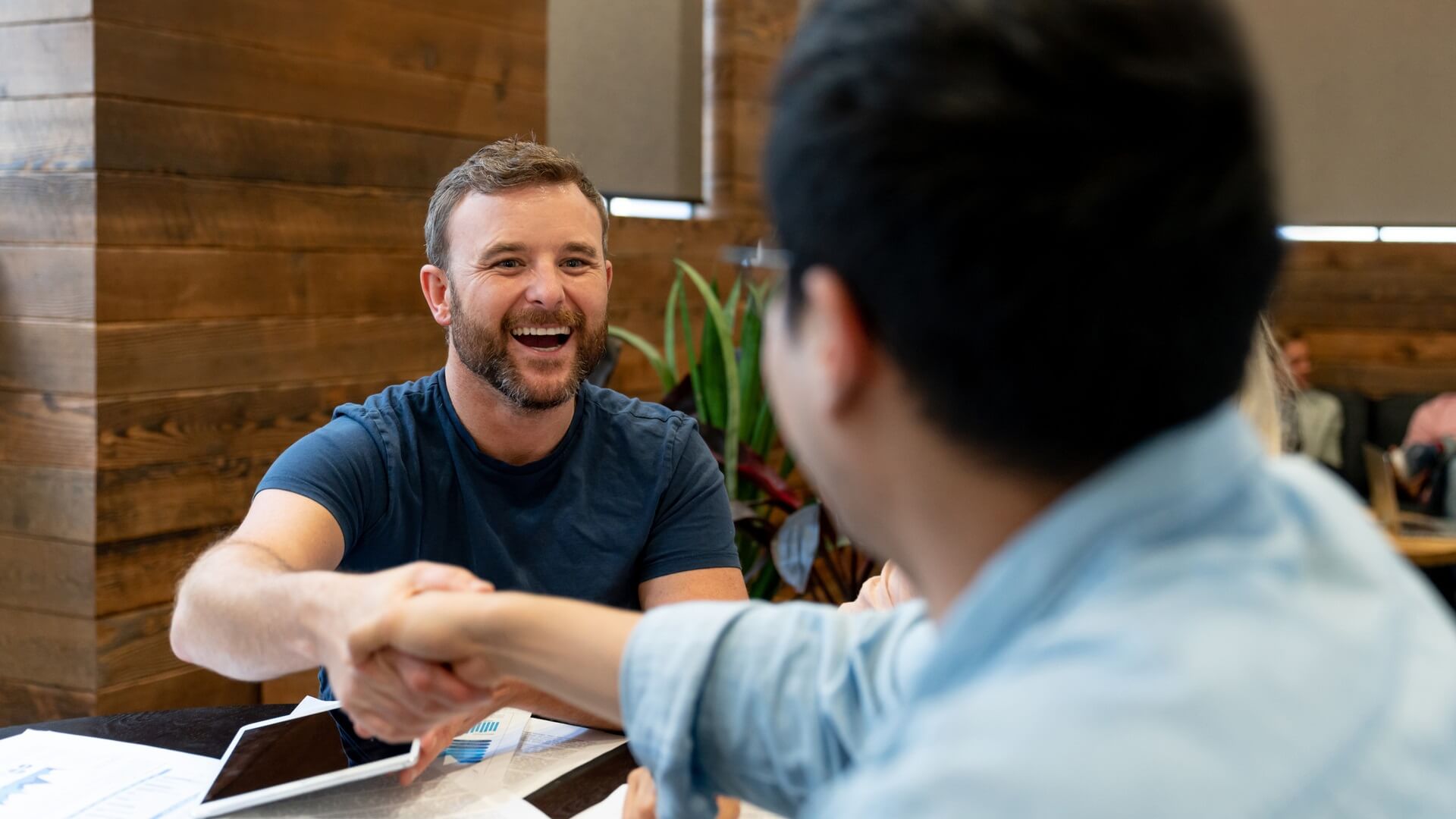 Two men shaking hands before a job interview