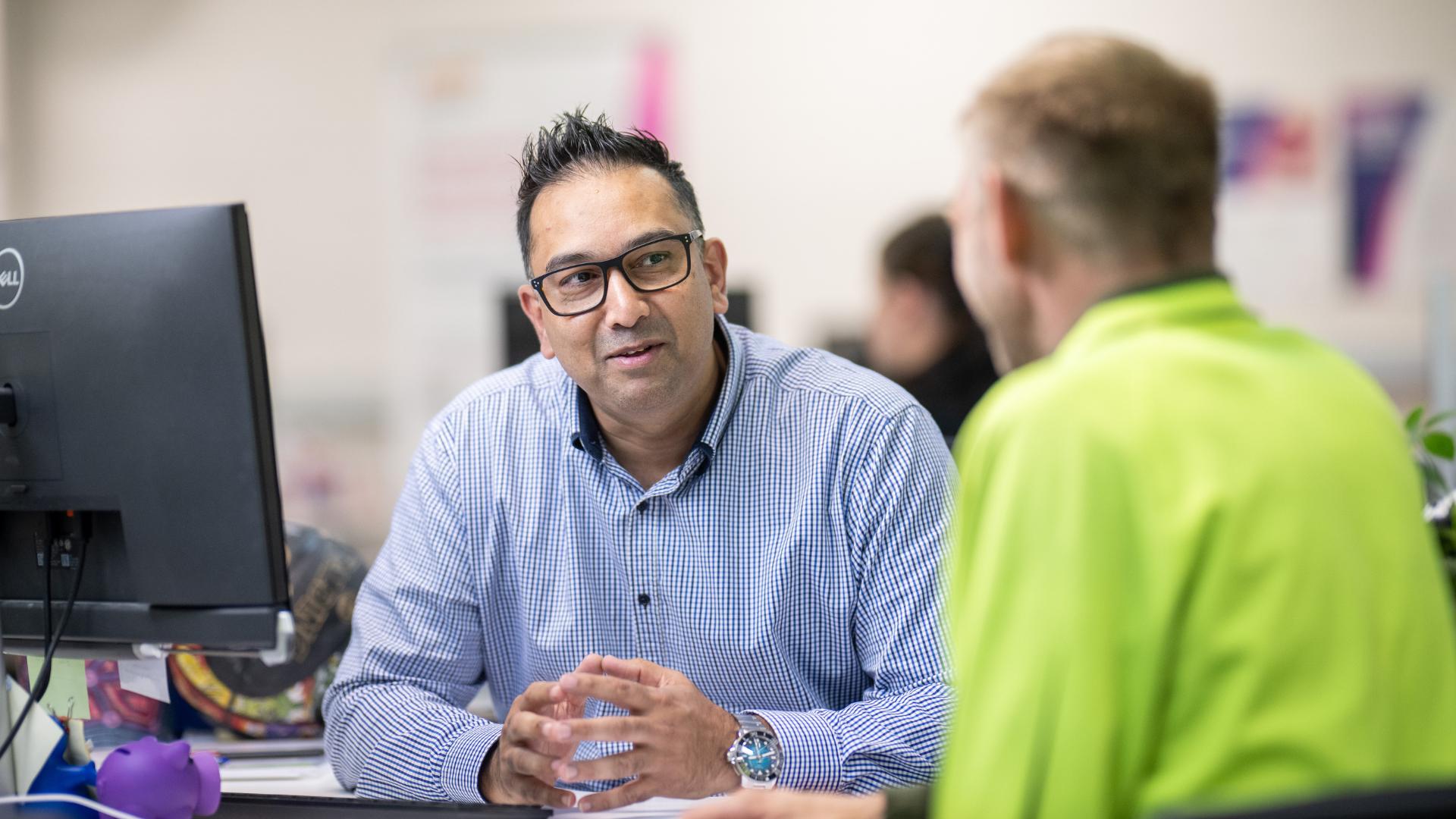 APM employment consultant interviews a job seeker in an APM Employment Services branch