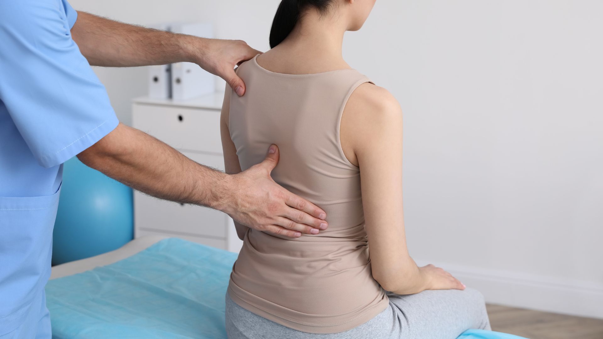 A woman with scoliosis has a medical exam