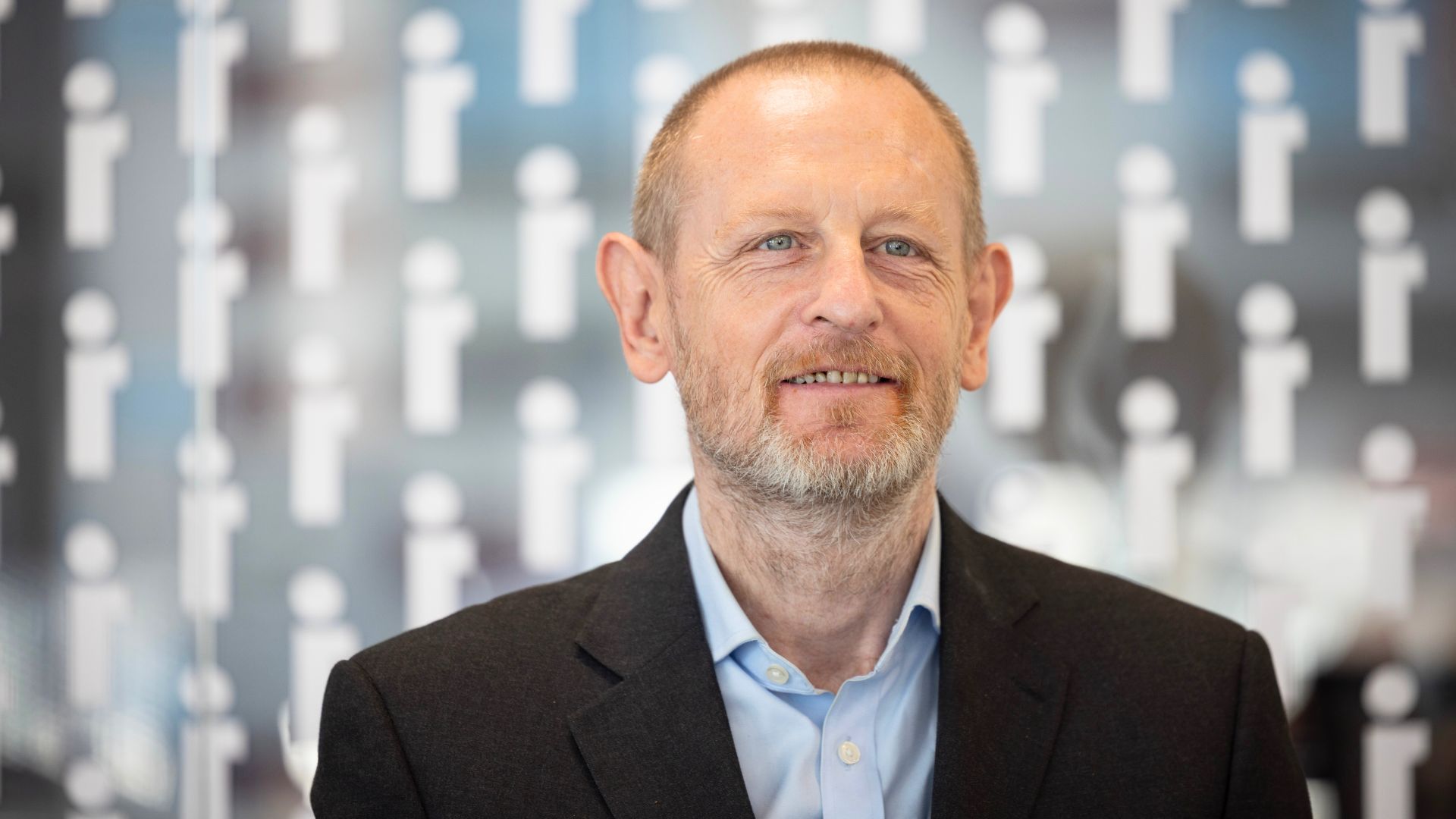 Francis smiling at a stadium, proud of his new job as a security guard