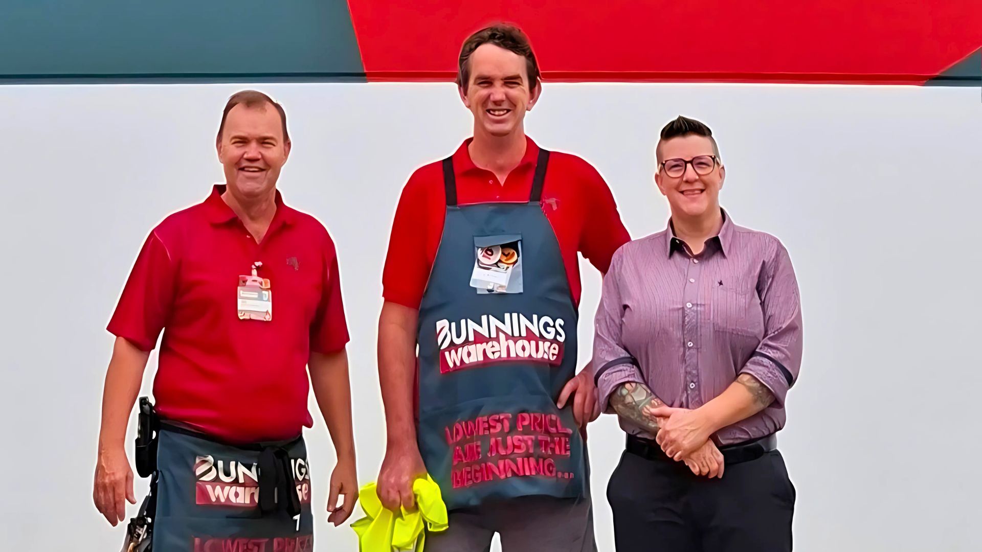 Two Bunnings employees with an APM consultant outside the hardware store