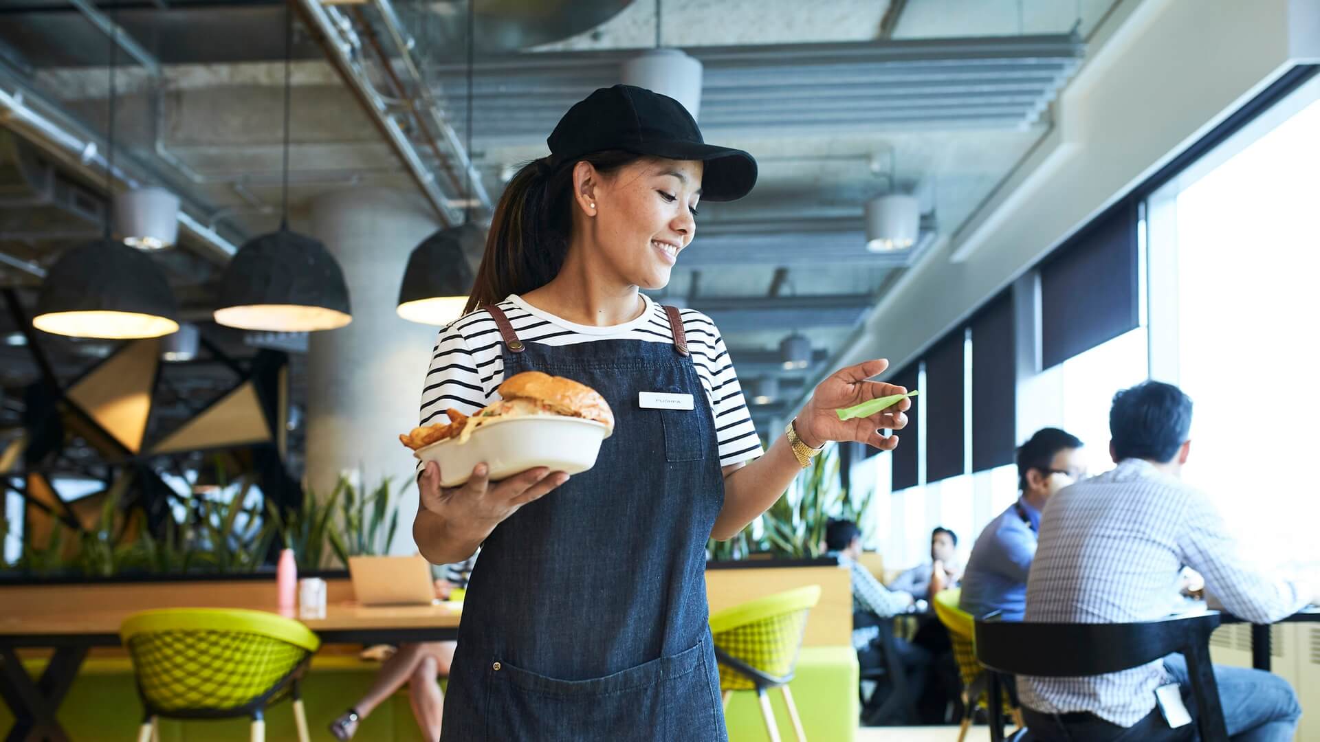 A fast food worker taking an order over to a customer