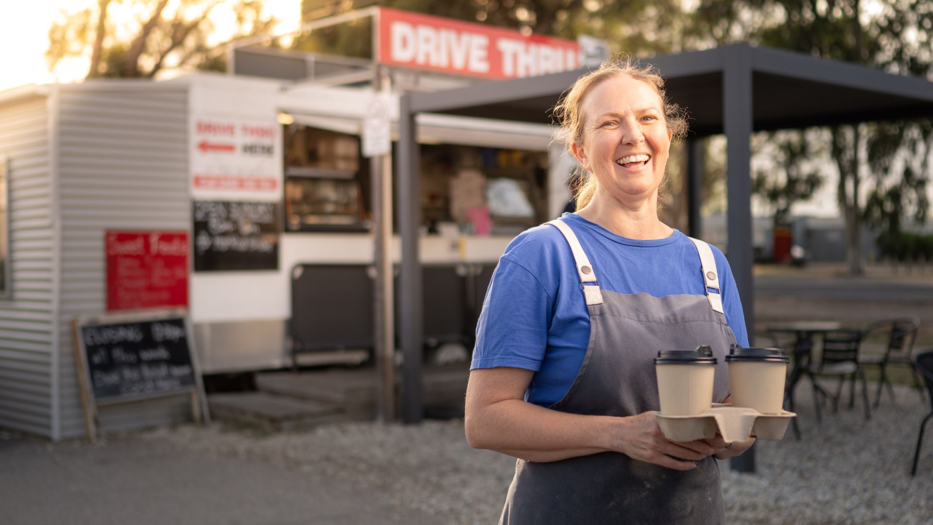 Megan smiles with coffees