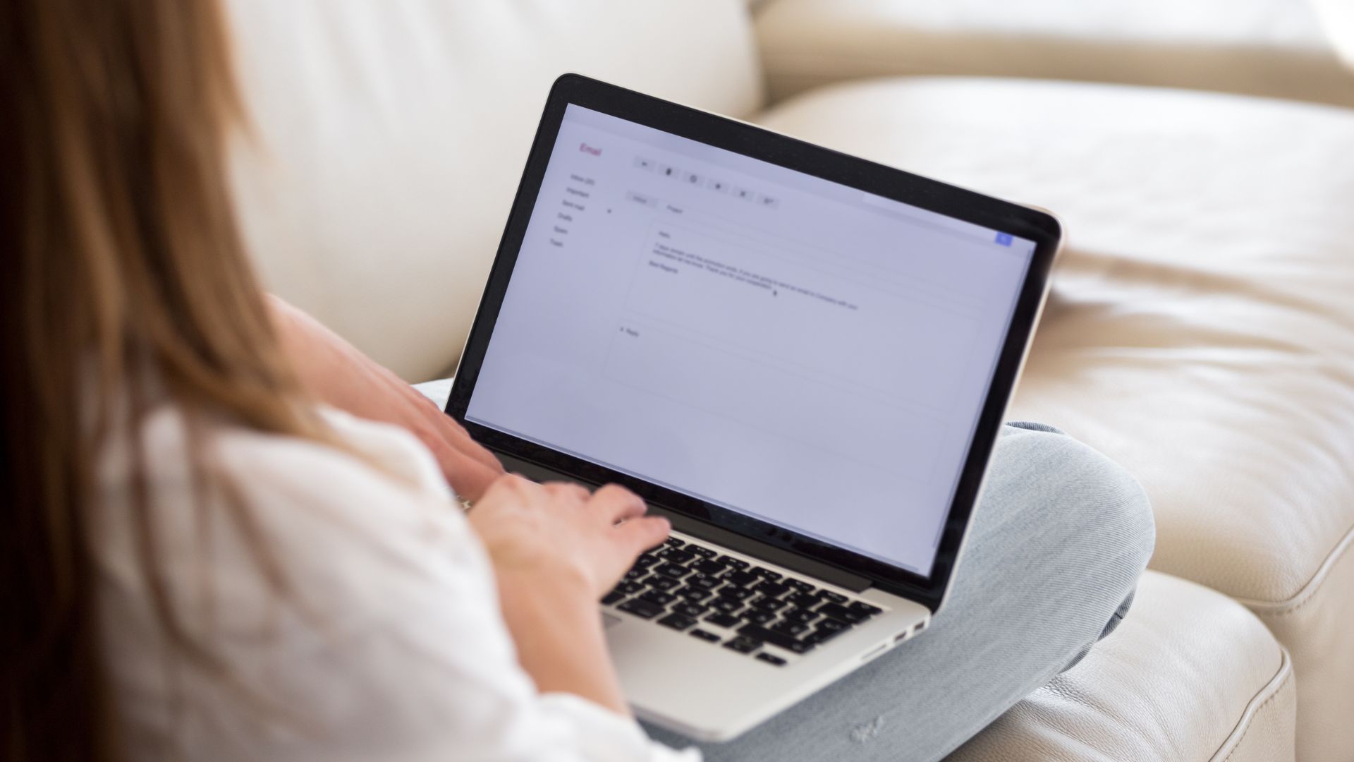 A woman's hands on a laptop