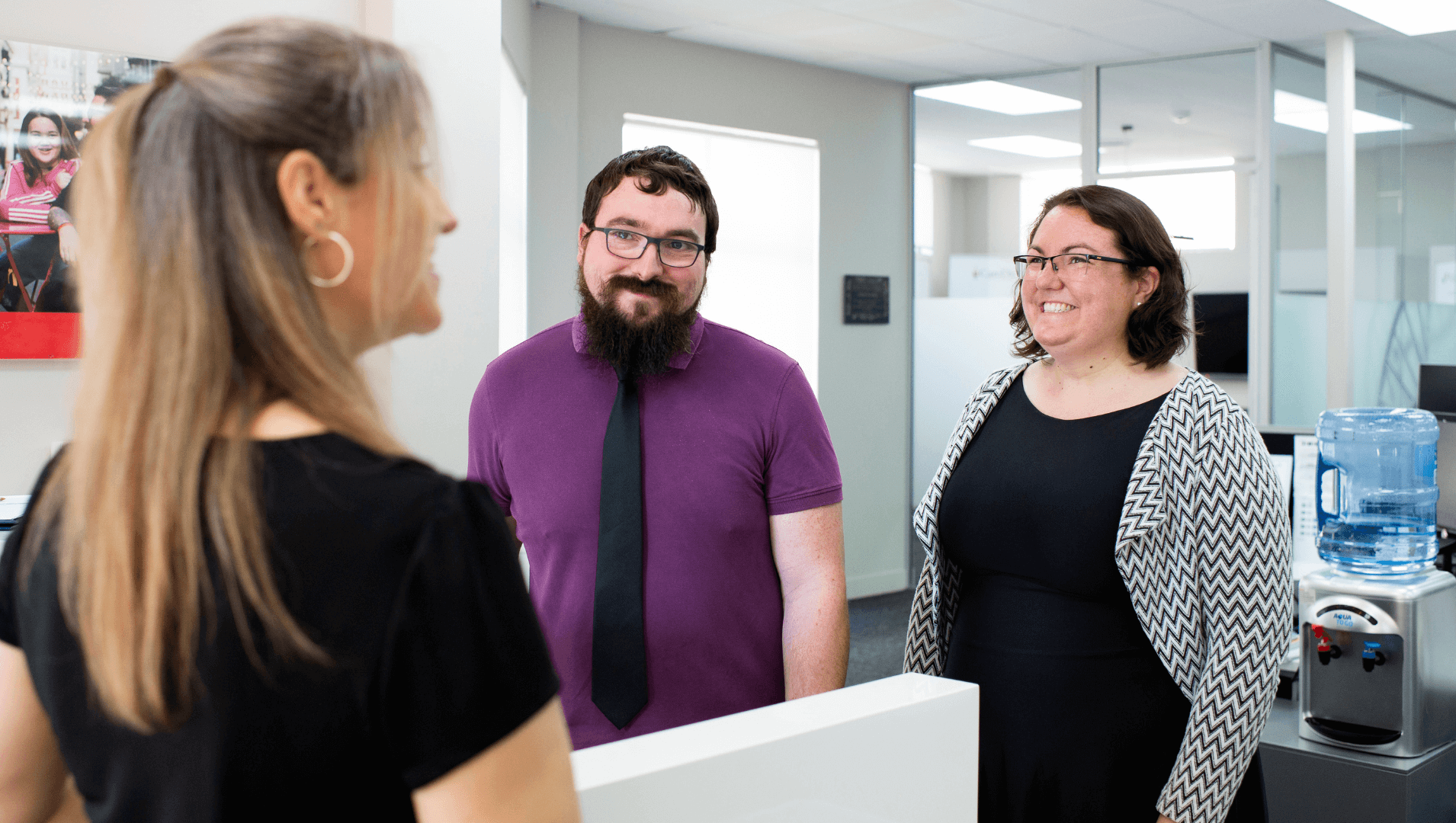 A DES participant chatting to two APM Employment Consultants