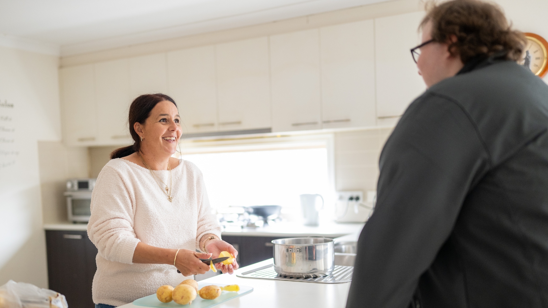 Nicole working as a support worker in a client's home, demonstrating a successful employment outcome achieved through Inclusive Employment Australia and APM Employment Services.