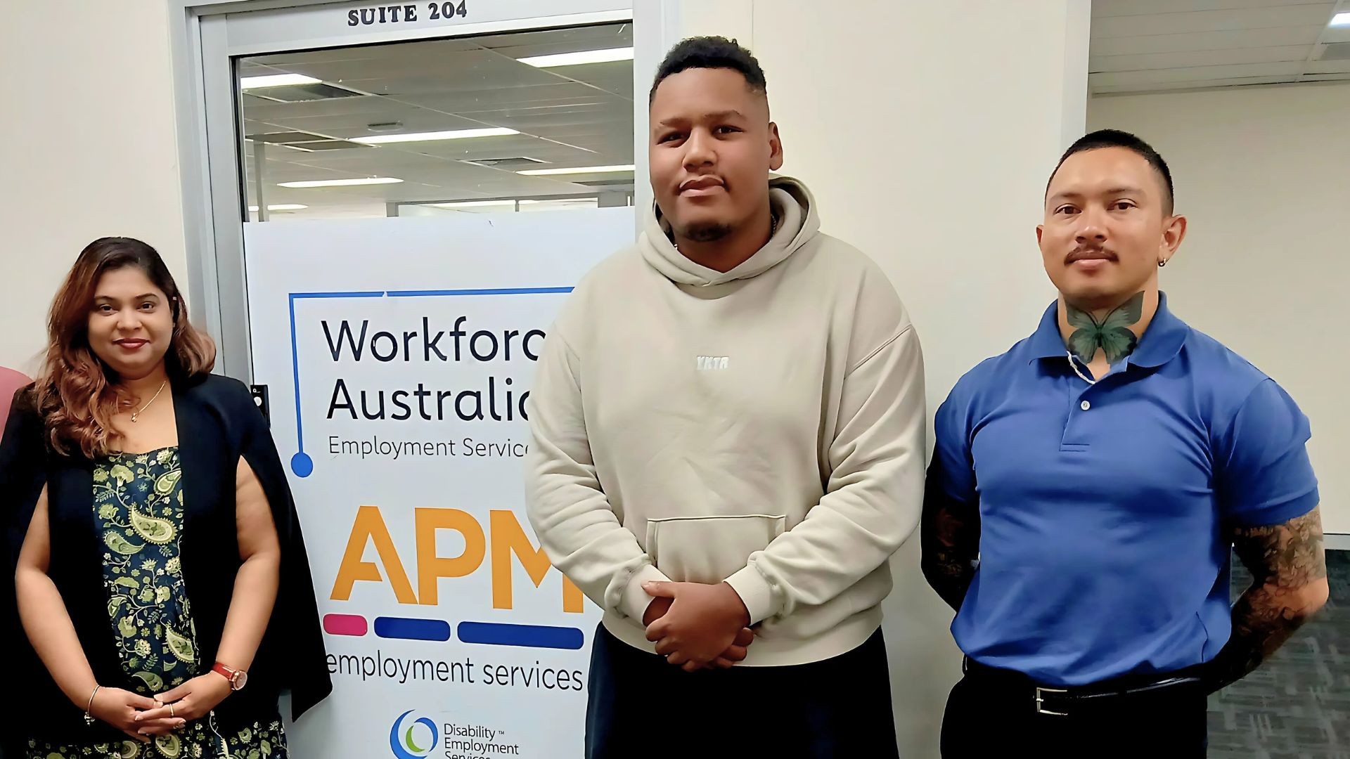 Workforce Australia participant Emmanuel stands between Mas and Khalil from APM Employment Services
