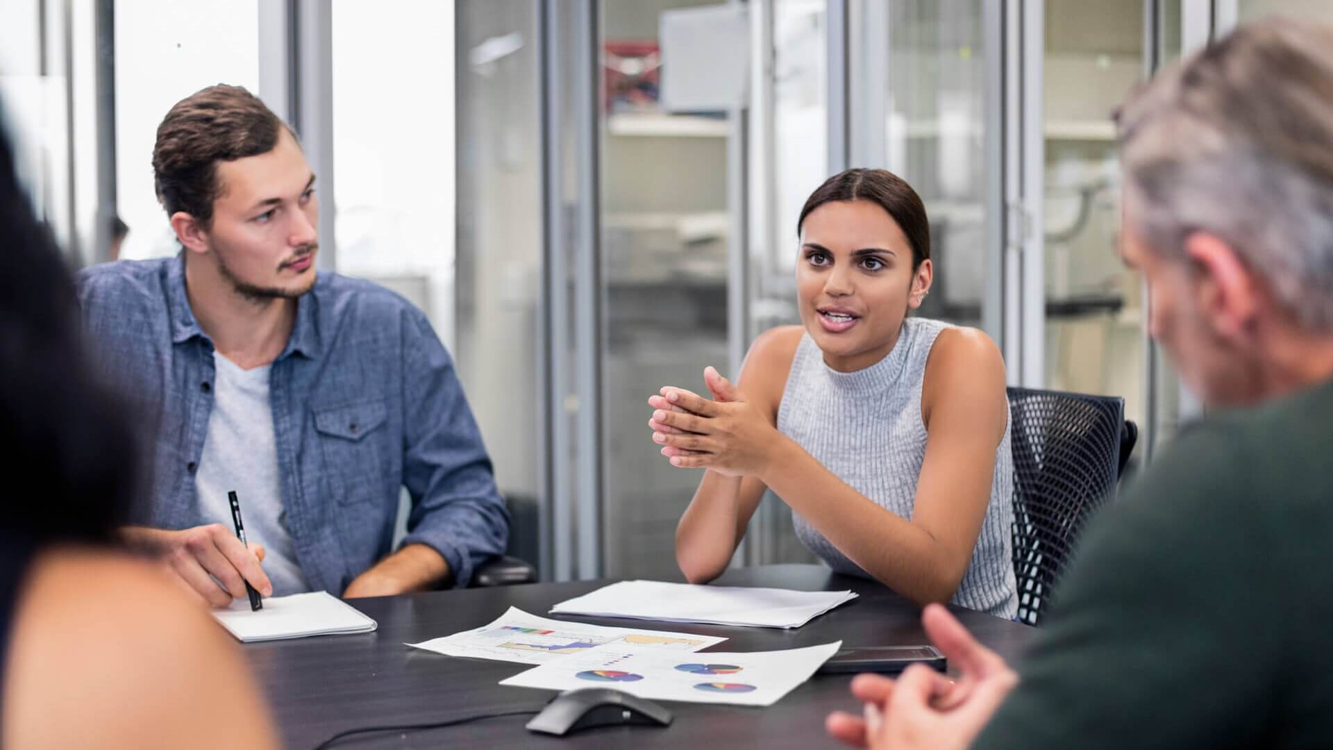 Four colleagues sitting around a table having a meeting