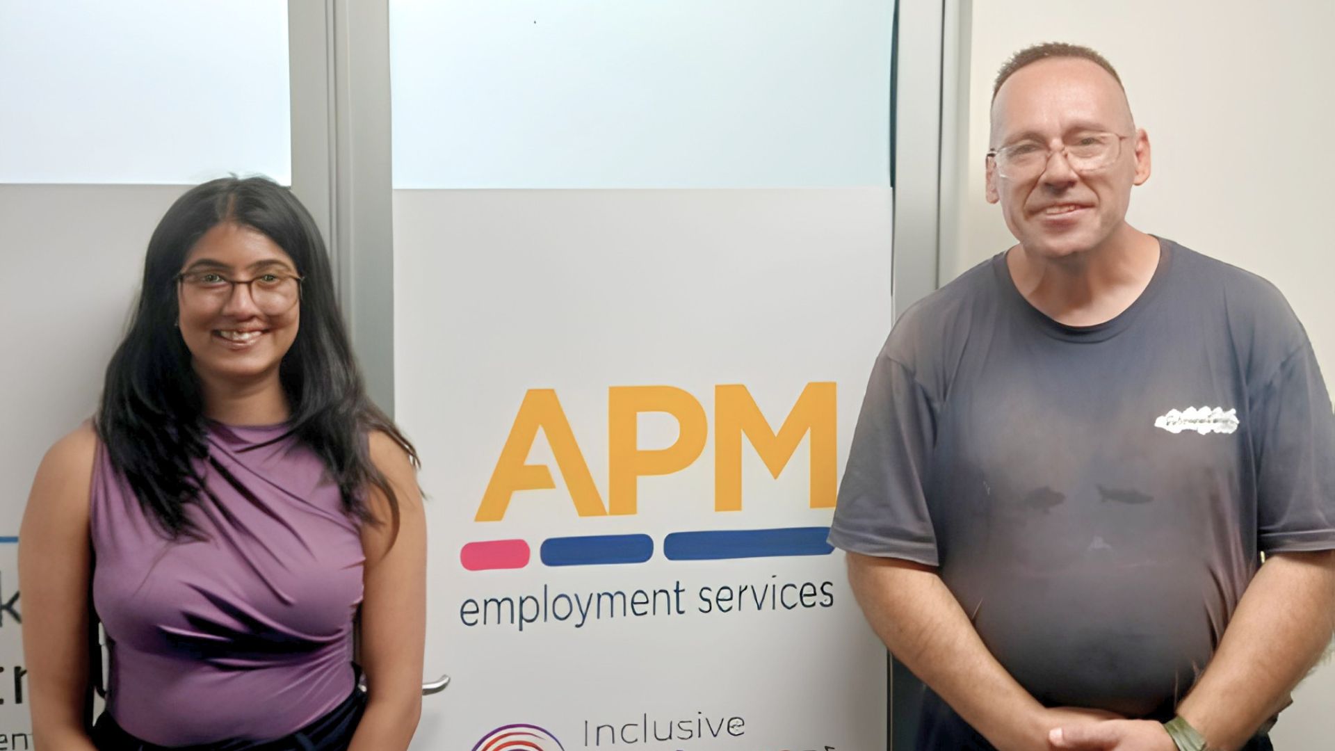 Workforce Australia participant Boby stands with an APM Employment Services consultant in the Surry Hills office.