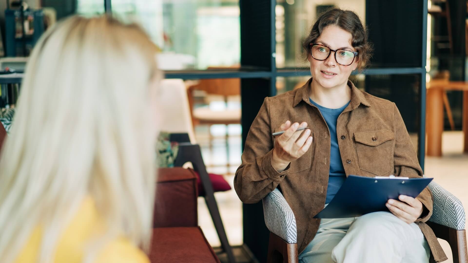 Two women chatting in a professional setting
