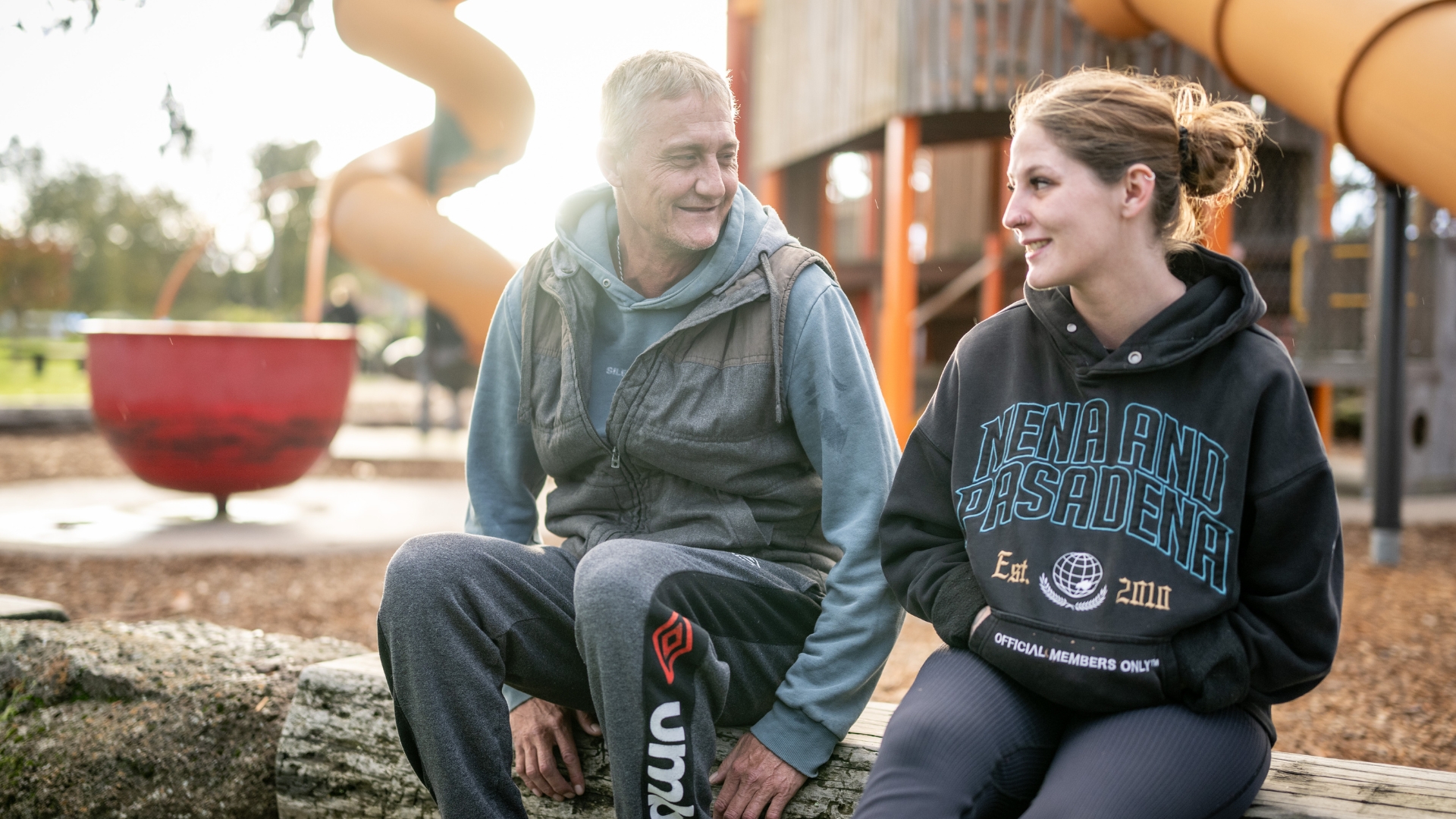 Paul sitting outdoors with another person in a community setting, demonstrating the supportive relationships and personalised assistance available through Inclusive Employment Australia and APM Employment Services.
