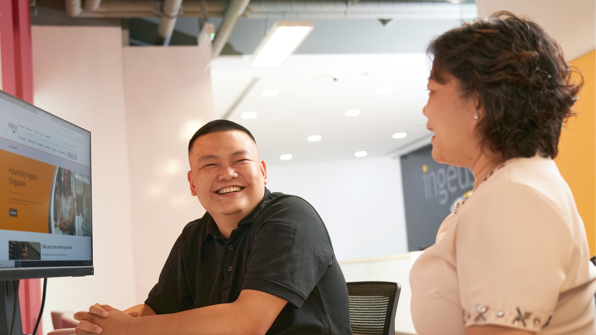 Joey participating in a career consultation session as part of the Polaris program at Ingeus Singapore, with a computer screen displaying program details.