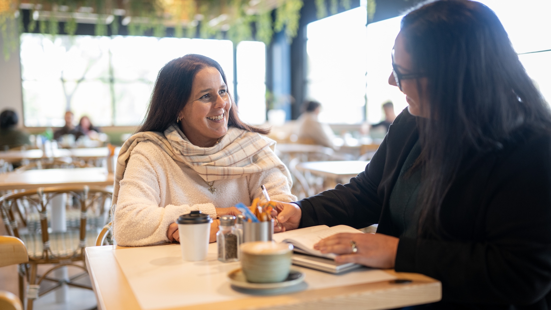 Nicole meeting with an APM Employment Services consultant to discuss employment goals and career opportunities through the Inclusive Employment Australia program.