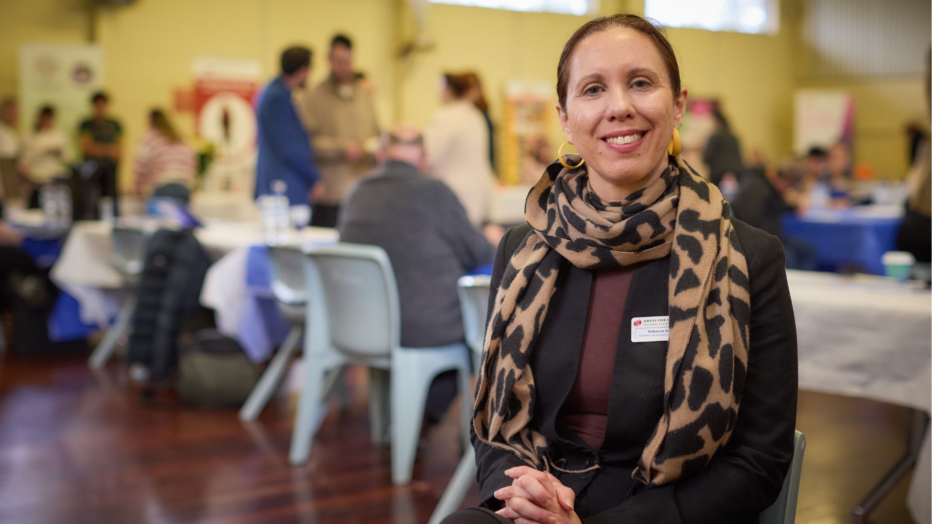 Rebecca from Dress for Success smiles at the community expo