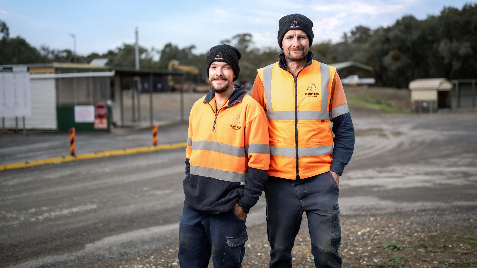 Angus stands with a team leader at the Alexandra Resource Recovery Centre, where he works in a maintenance and customer service role after receiving support through Inclusive Employment Australia delivered by APM.