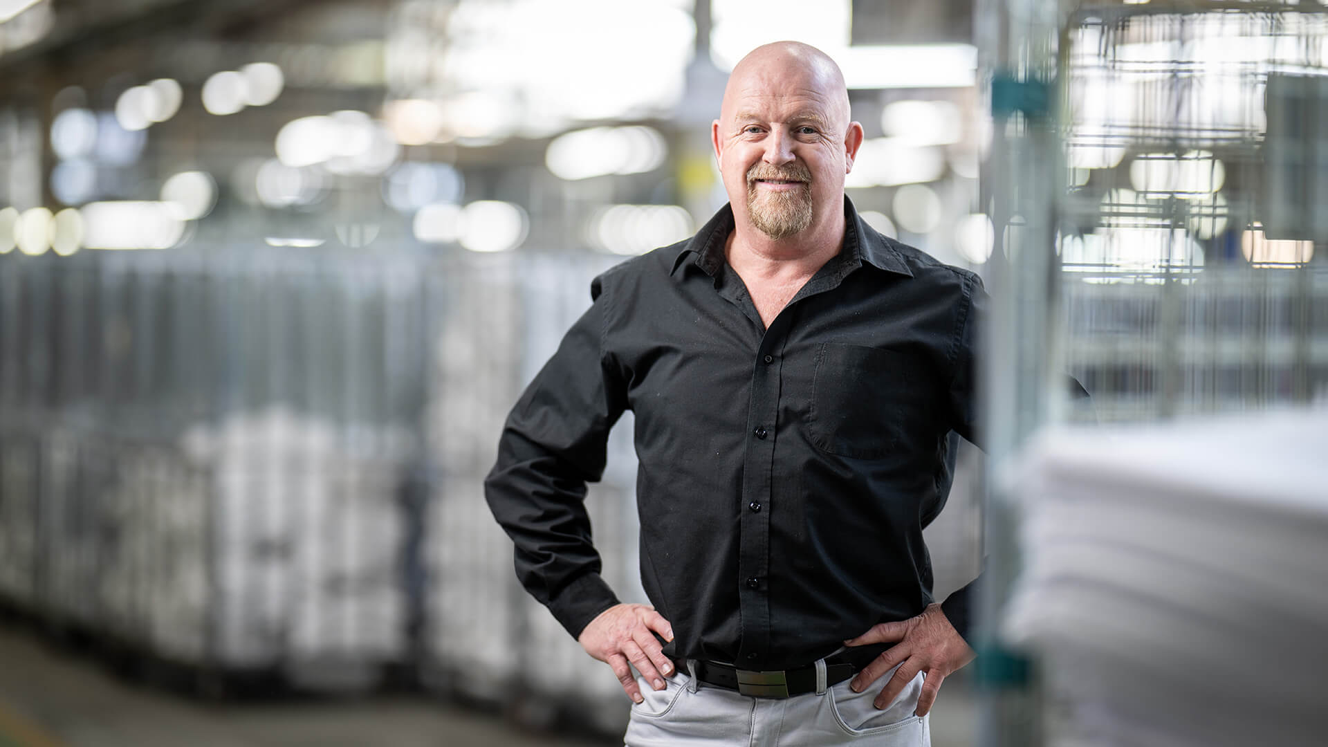 Paul smiles in the laundry warehouse