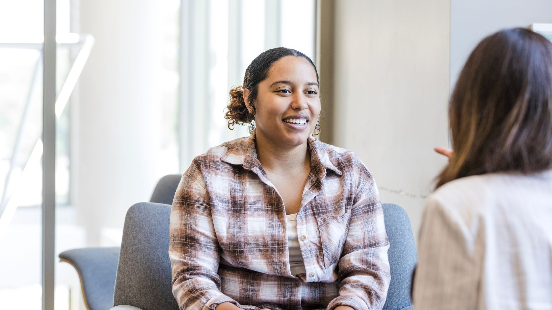 Woman on couch speaking to psychologist