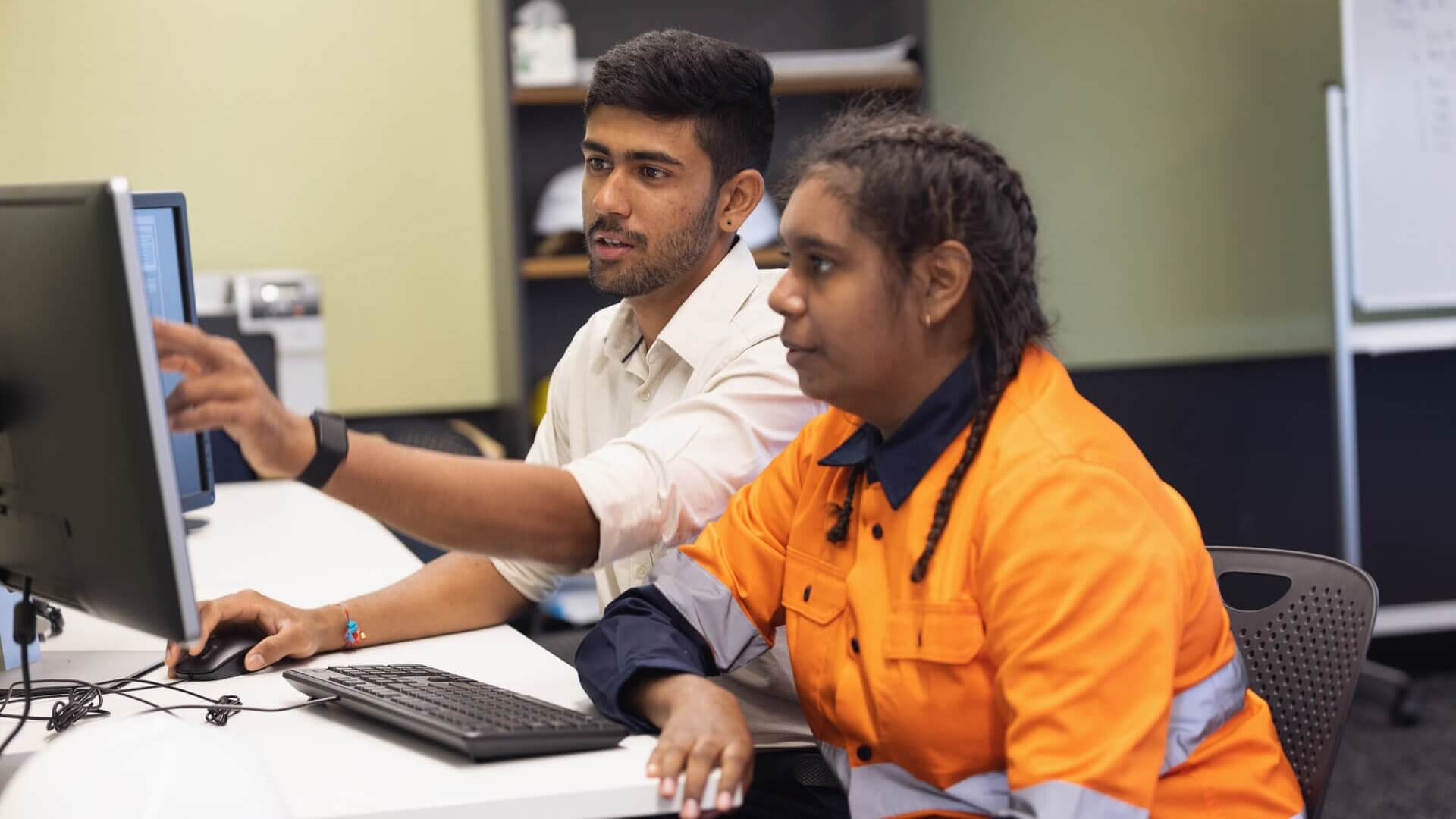 Two people sitting at a computer