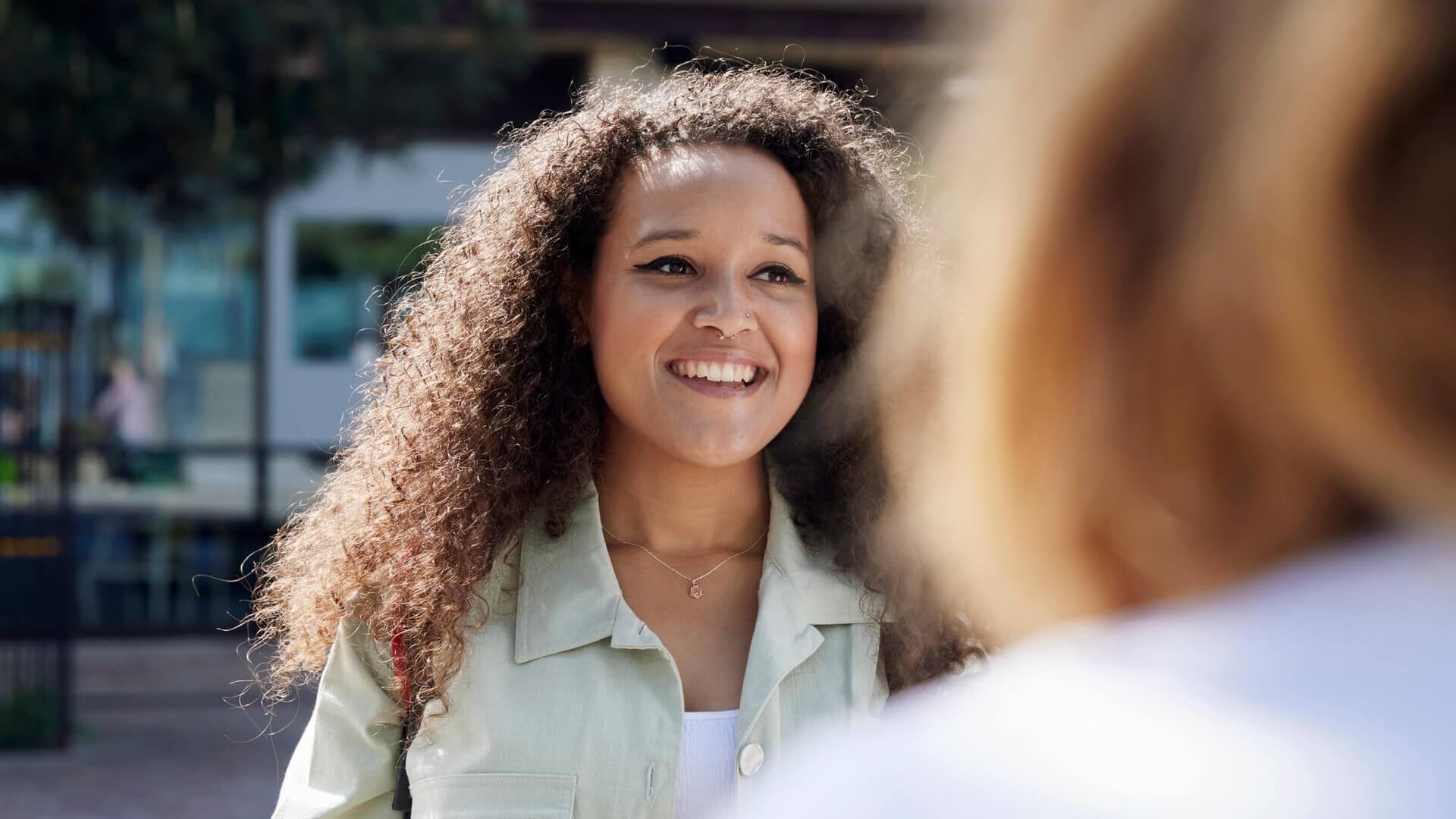 A woman talking to someone outside the office