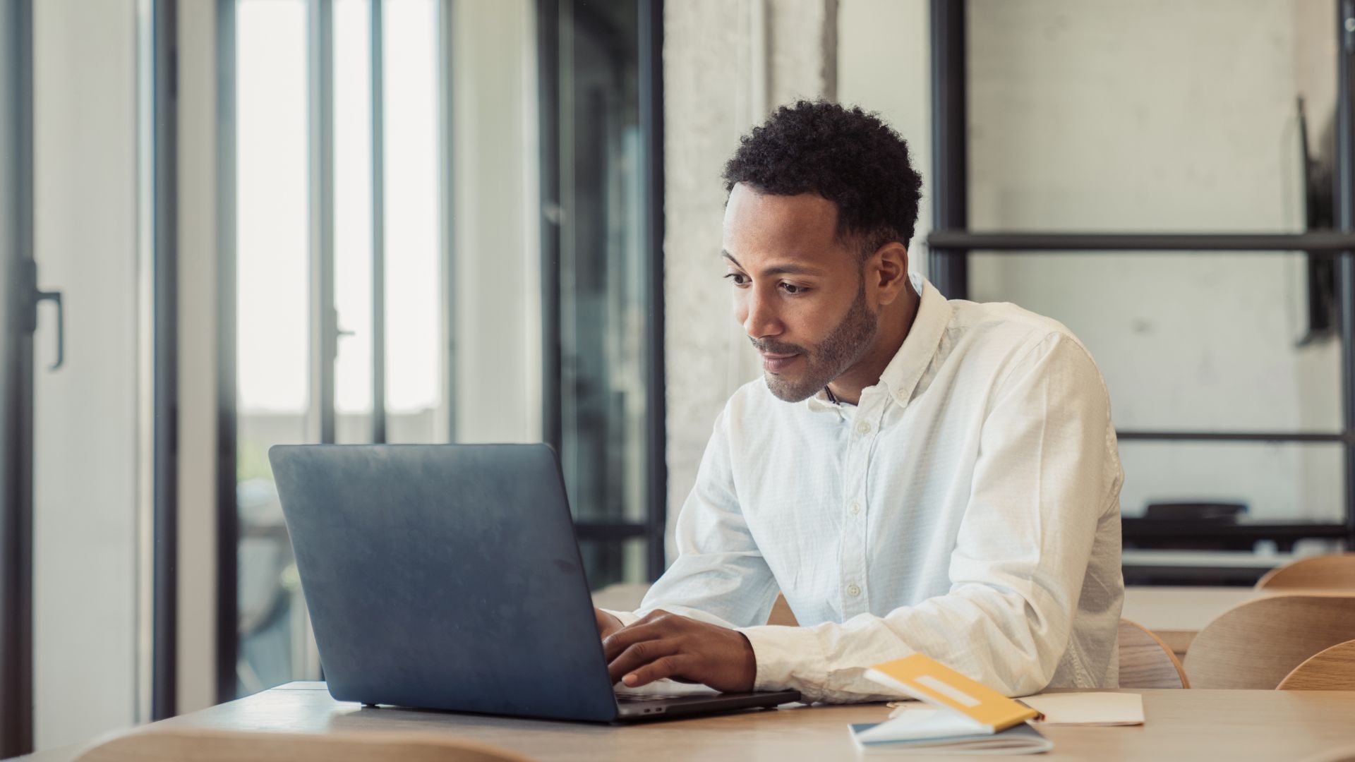 A man reviewing a professional resume template on a laptop screen