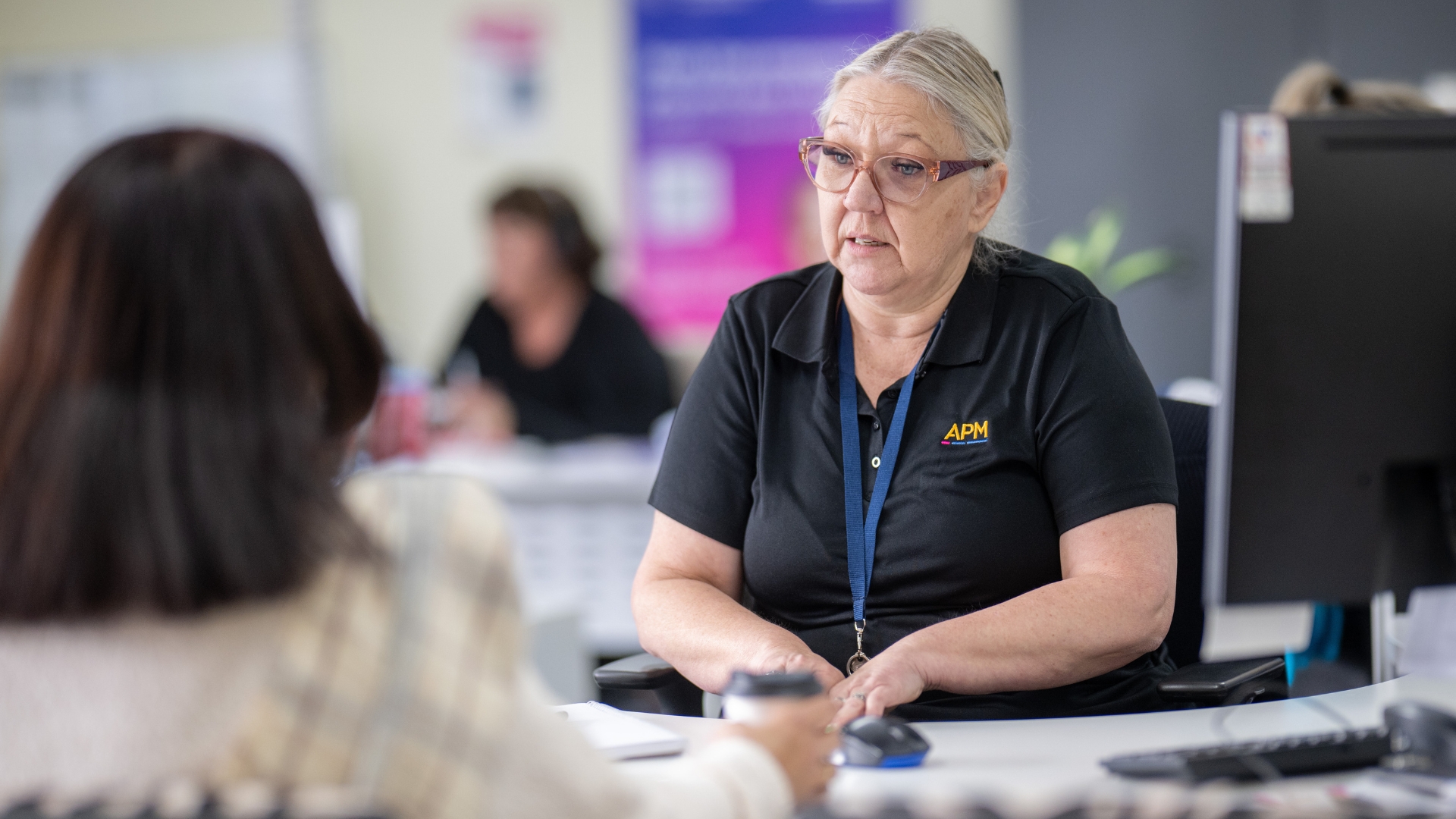 Nicole sitting with an employment consultant during a planning session, exploring work opportunities and pathways to employment through Inclusive Employment Australia and APM Employment Services.