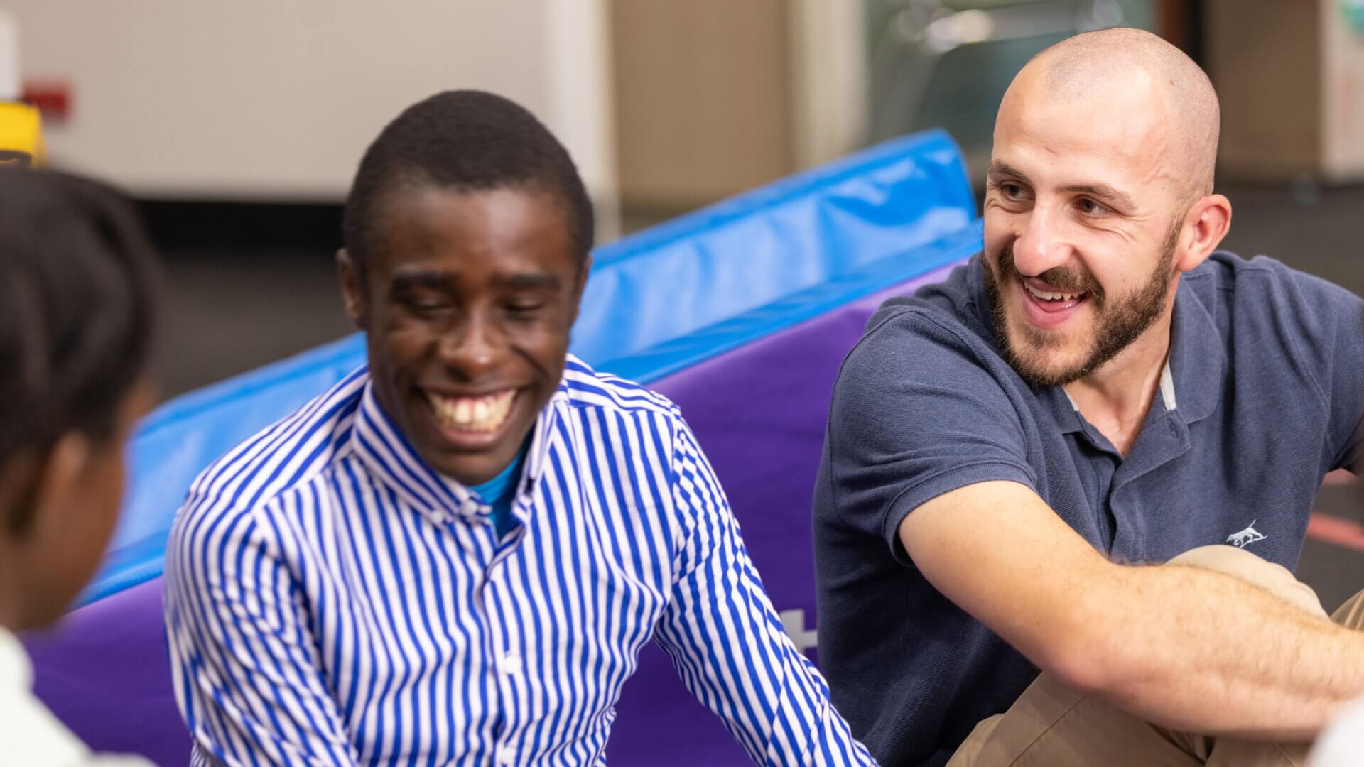 Bale and Apo sitting next to each other laughing