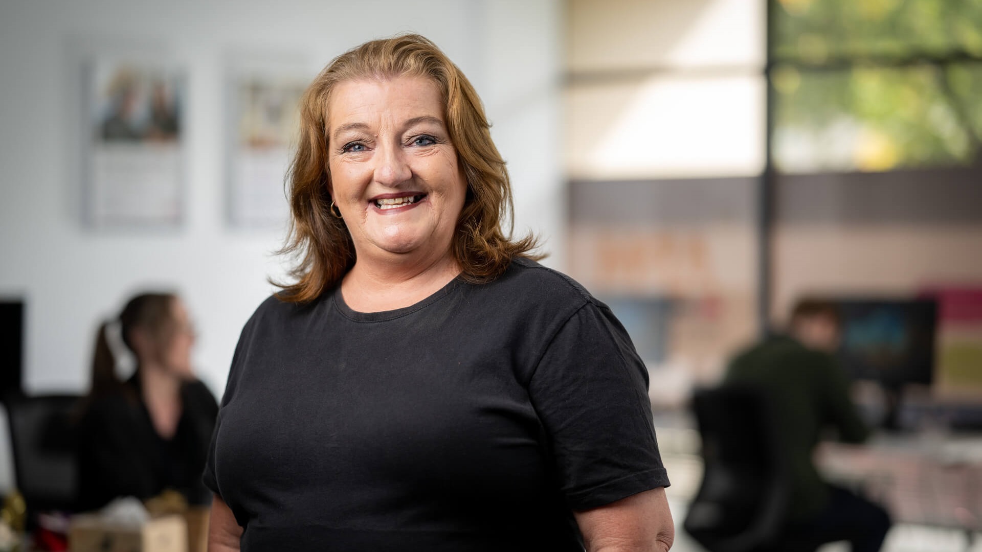 DES participant Robyn smiles in a black top