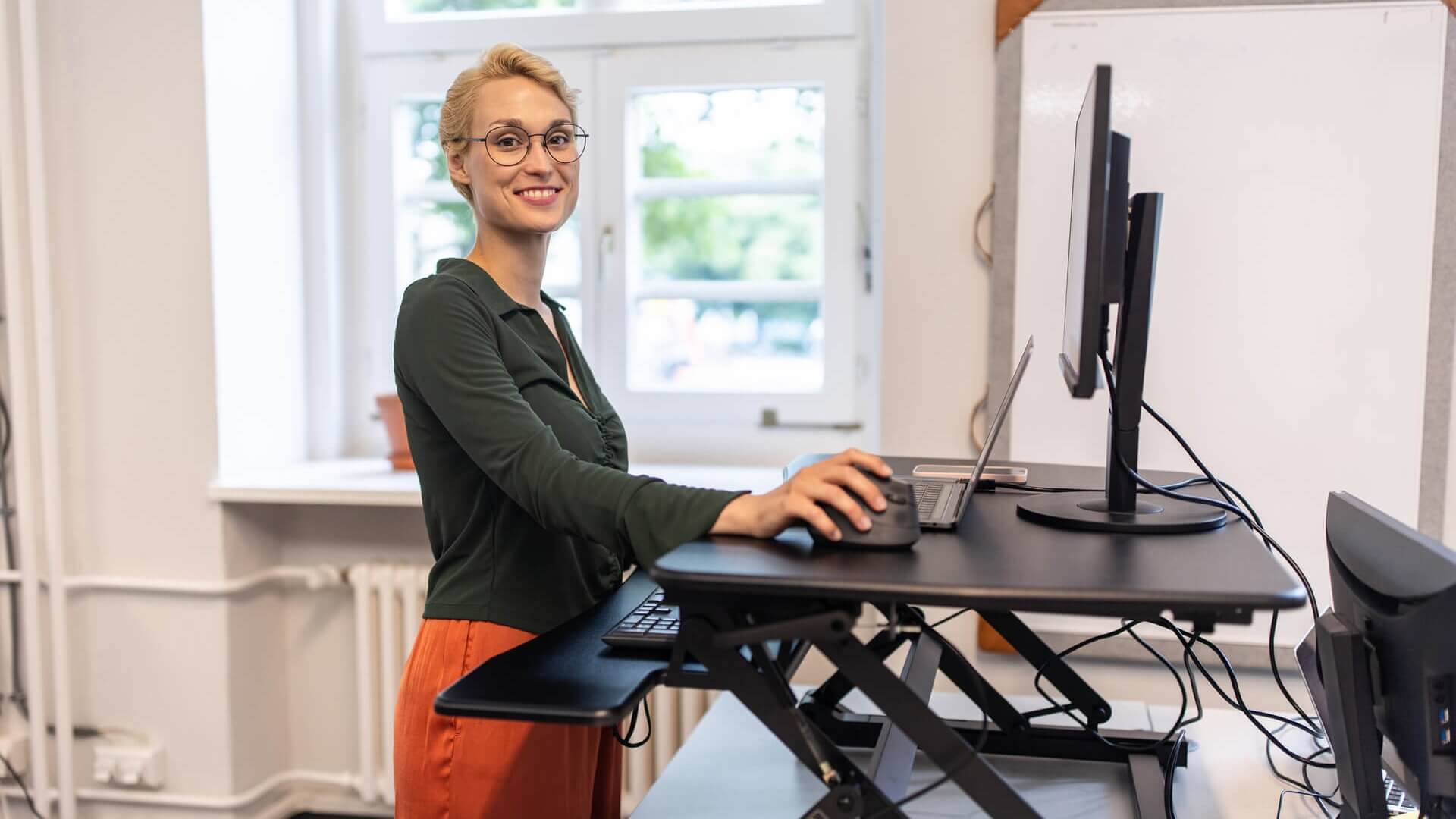 A woman working at a standing desk